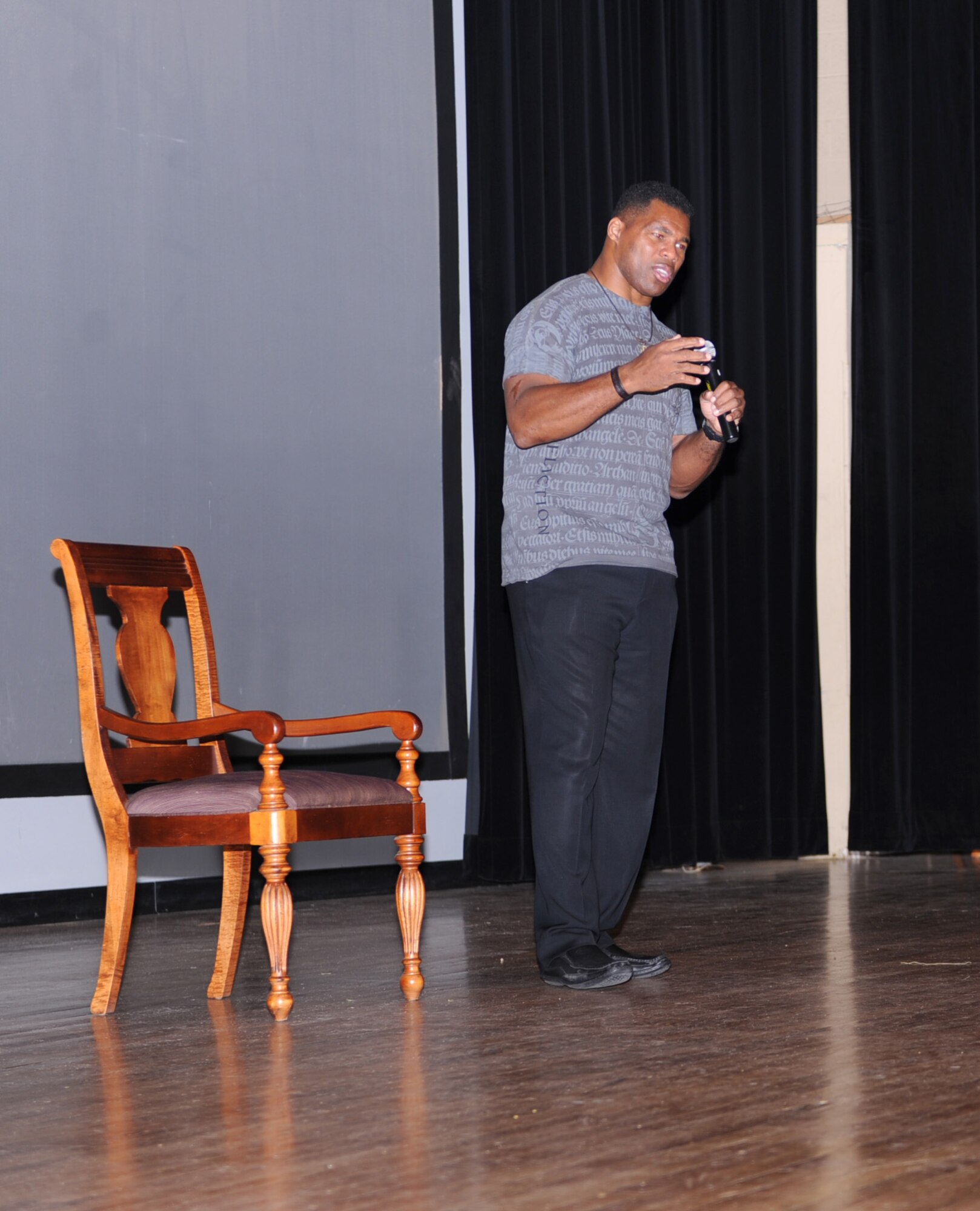 Herschel Walker talks to Airmen about his past experiences at the base theater on Davis-Monthan Air Force Base, Ariz., Sept. 21. (U.S. Air Force photo by Airman 1st Class Michael Washburn/Released)