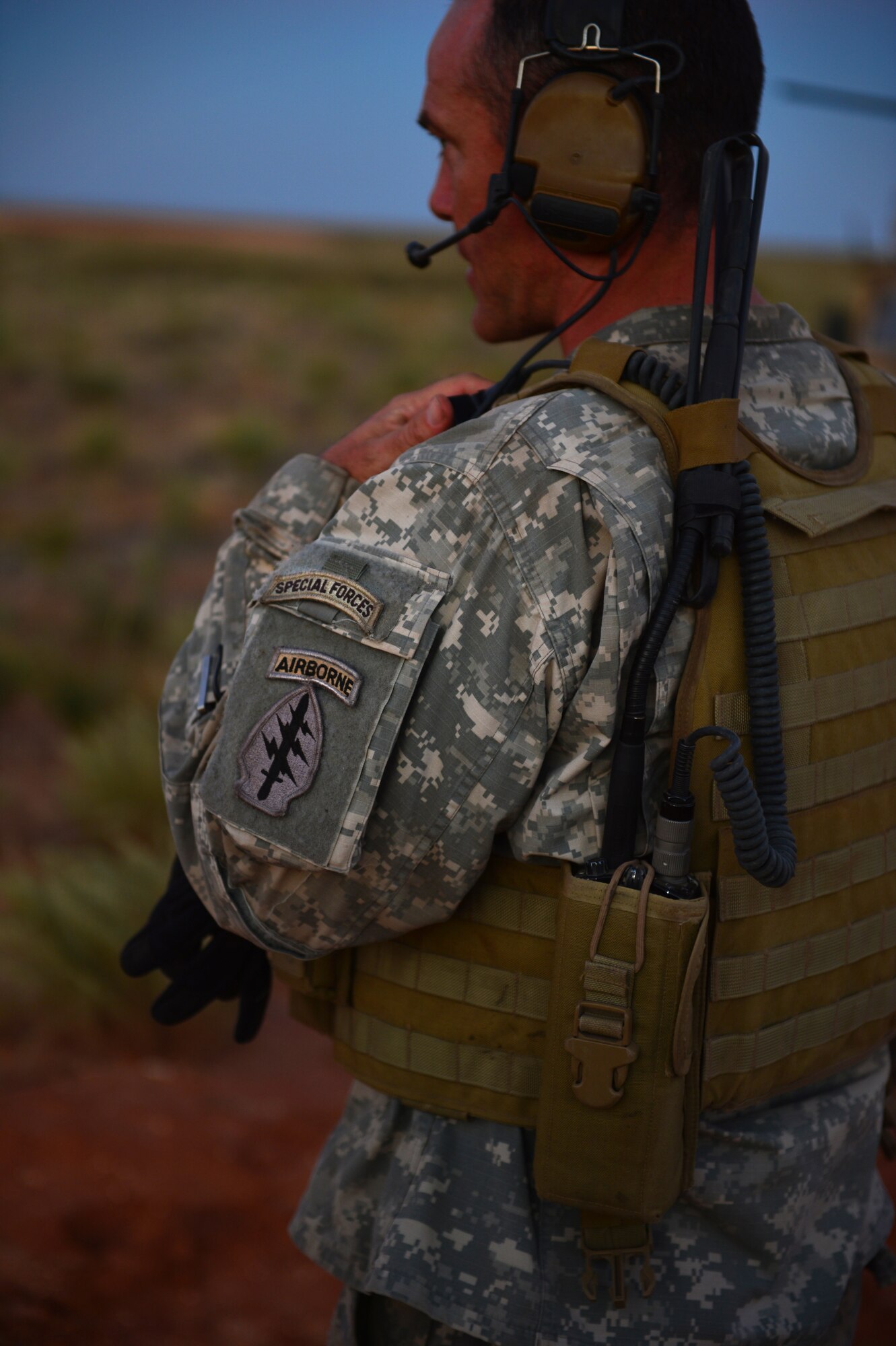 A soldier with the 19th Special Forces Group communicates via headset with aircrew at Melrose Air Force Range, N.M., Sept. 19, 2012. Melrose has been an integral part of Cannon Air Force Base, N.M., since the early 1950s. (U.S. Air Force photo/Airman 1st Class Eboni Reece)
