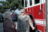 Airman 1st Class Kevin Lutker (right), 902nd Civil Engineer Squadron firefighter, explains fire emergency equipment to Gertie Wagner during the retiree appreciation event held at Joint Base San Antonio-Randolph, Texas, Sept. 22. The event is held annually at the Kendrick Club to educate the local retiree community on services available to them. (U.S. Air Force photo by Rich McFadden) 