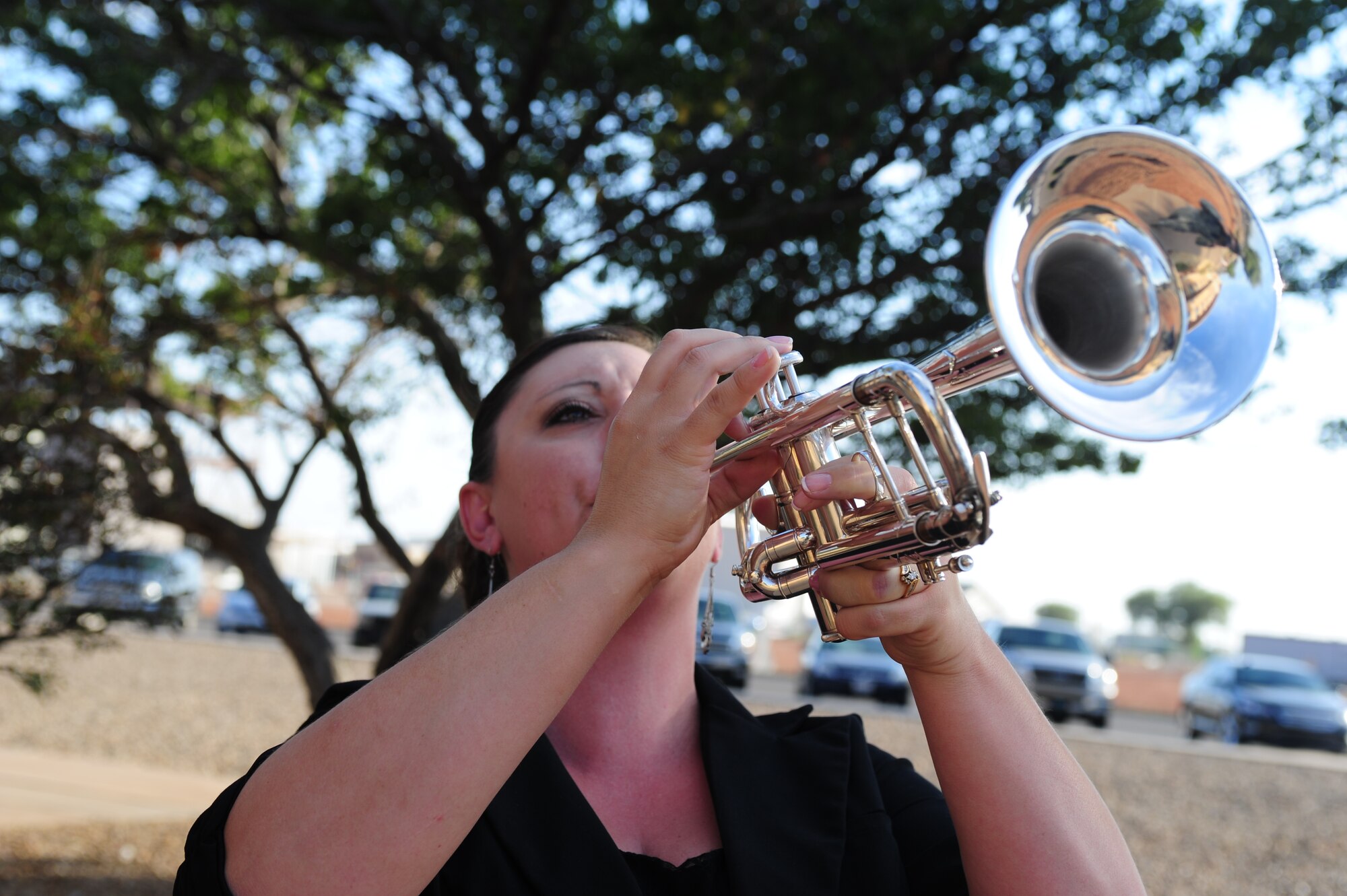 Tyleen Caffrey, local musician, plays taps at the Prisoner of War/Missing in Action Ceremony at Cannon Air Force Base, N.M., Sept. 21, 2012. The ceremony was held in honor of those service members who have fallen into enemy hands or have never been recovered. (U.S. Air Force photo by Airman 1st Class Ericka Engblom)