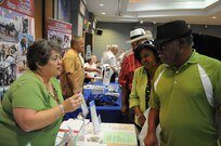 Rosalyn Wise (left), Primerica volunteer, provides information to Ken Farrington (right) and his wife Terry during the retiree appreciation event held at Joint Base San Antonio-Randolph, Texas, Sept. 22. The event is held annually at the Kendrick Club to educate the local retiree community on services available to them. (U.S. Air Force photo by Rich McFadden) 