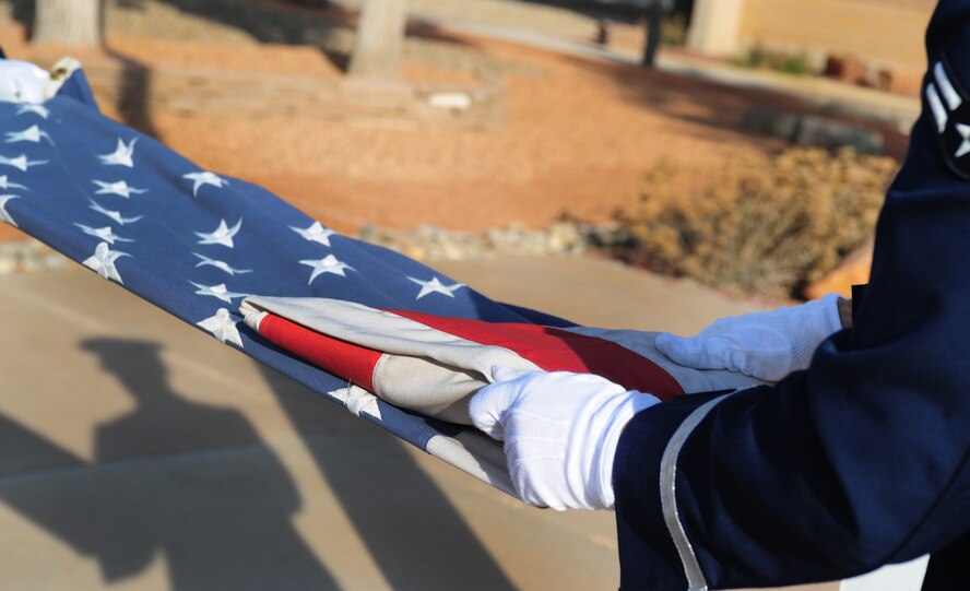 Members of Honor Guard fold the American Flag at the Prisoner of War/Missing in Action Ceremony at Cannon Air Force Base, N.M., Sept. 21, 2012. The ceremony was held in honor of those service members who have fallen into enemy hands or have never been recovered. (U.S. Air Force photo by Airman 1st Class Ericka Engblom)