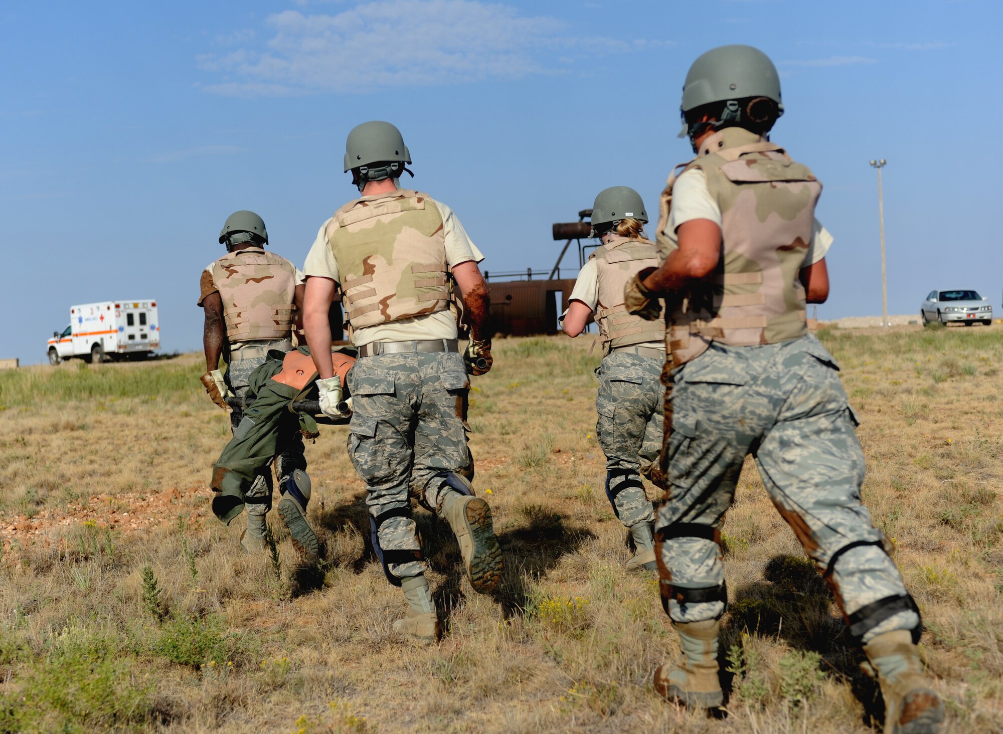 The emergency medical team from Kirtland Air Force Base, N.M., sprints toward the finish line during the obstacle course segment of the Emergency Medical Technician Rodeo at Cannon Air Force Base, N.M., Sept. 22, 2012. The EMT Rodeo is a competition in which EMT teams from across the United States and Germany test their skills in various events that simulate real life scenarios. (U.S. Air Force photo/Airman 1st Class Xavier Lockley)