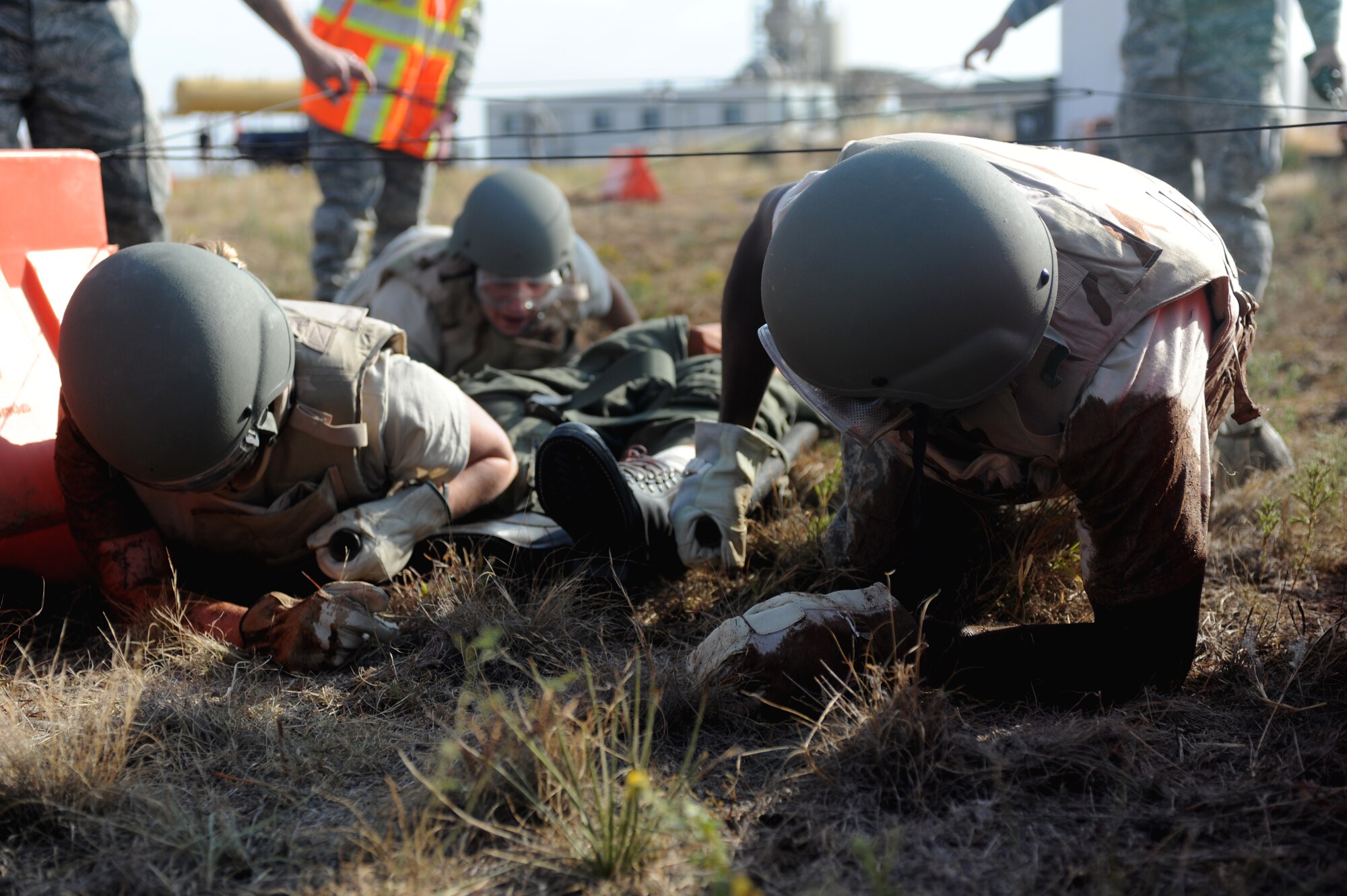 The emergency medical team from Kirtland Air Force Base, N.M., crawls through an obstacle course as part of the Emergency Medical Technician Rodeo at Cannon Air Force Base, N.M., Sept. 22, 2012. The EMT Rodeo is a competition in which EMT teams from across the United States and Germany test their skills in various events that simulate real life scenarios. (U.S. Air Force photo/Airman 1st Class Xavier Lockley)