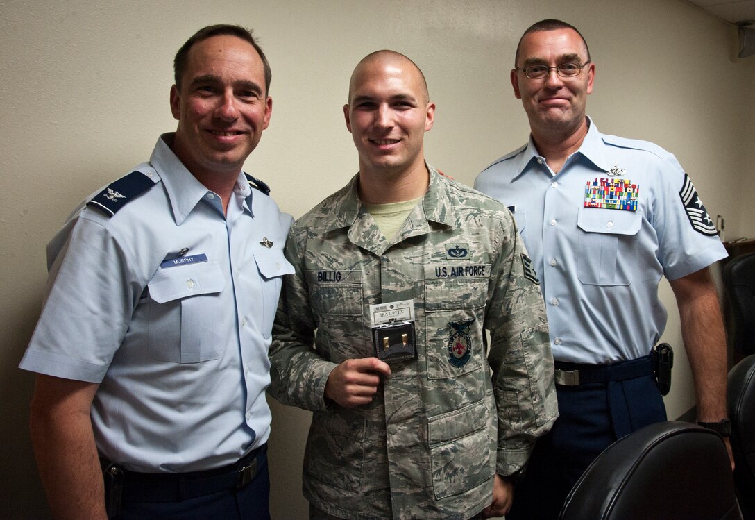 Staff Sgt. Curtis Billig, 47th Civil Engineer Squadron firefighter, poses with Col. Tom Murphy, 47th Flying Training Wing commander, and Chief Master Sgt. Garry Berry, 47th FTW command chief, while holding up his future second lieutenant rank bars after learning he was accepted to OTS Sept. 10, 2012. Billig will be going to OTS in the spring and is slated for a rated position which could see him returning to Laughlin as a student pilot. (U.S. Air Force photo/Airman 1st Class Nathan Maysonet)