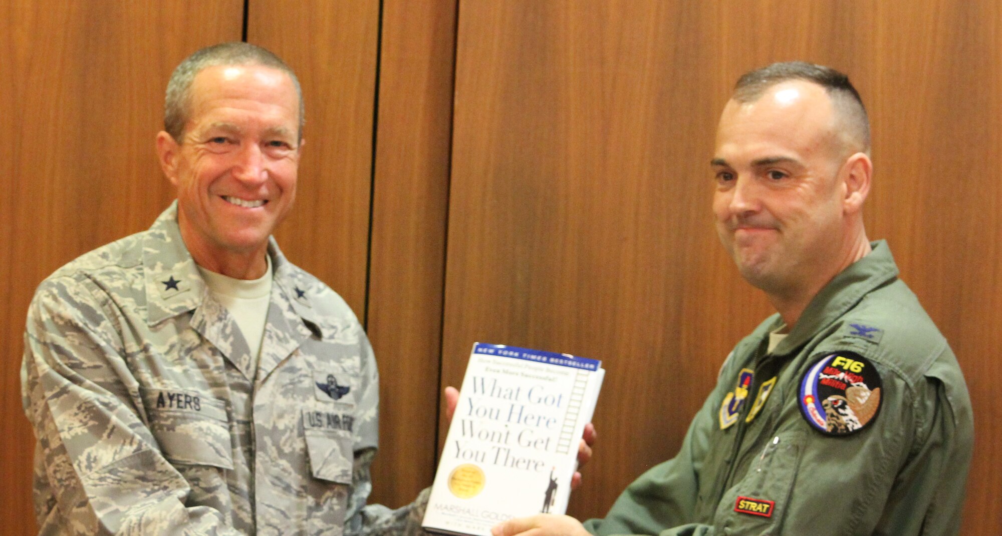 Col. Ed Vaughan of Montgomery, Ala., co-founder of the Guard and Reserve Network (GARNET), presents a book to Brig. Gen Paul Ayers of Leesburg, Virginia, following Ayers’ presentation to a GARNET meeting in Montgomery, June 27, 2012. (USAF courtesy photo)