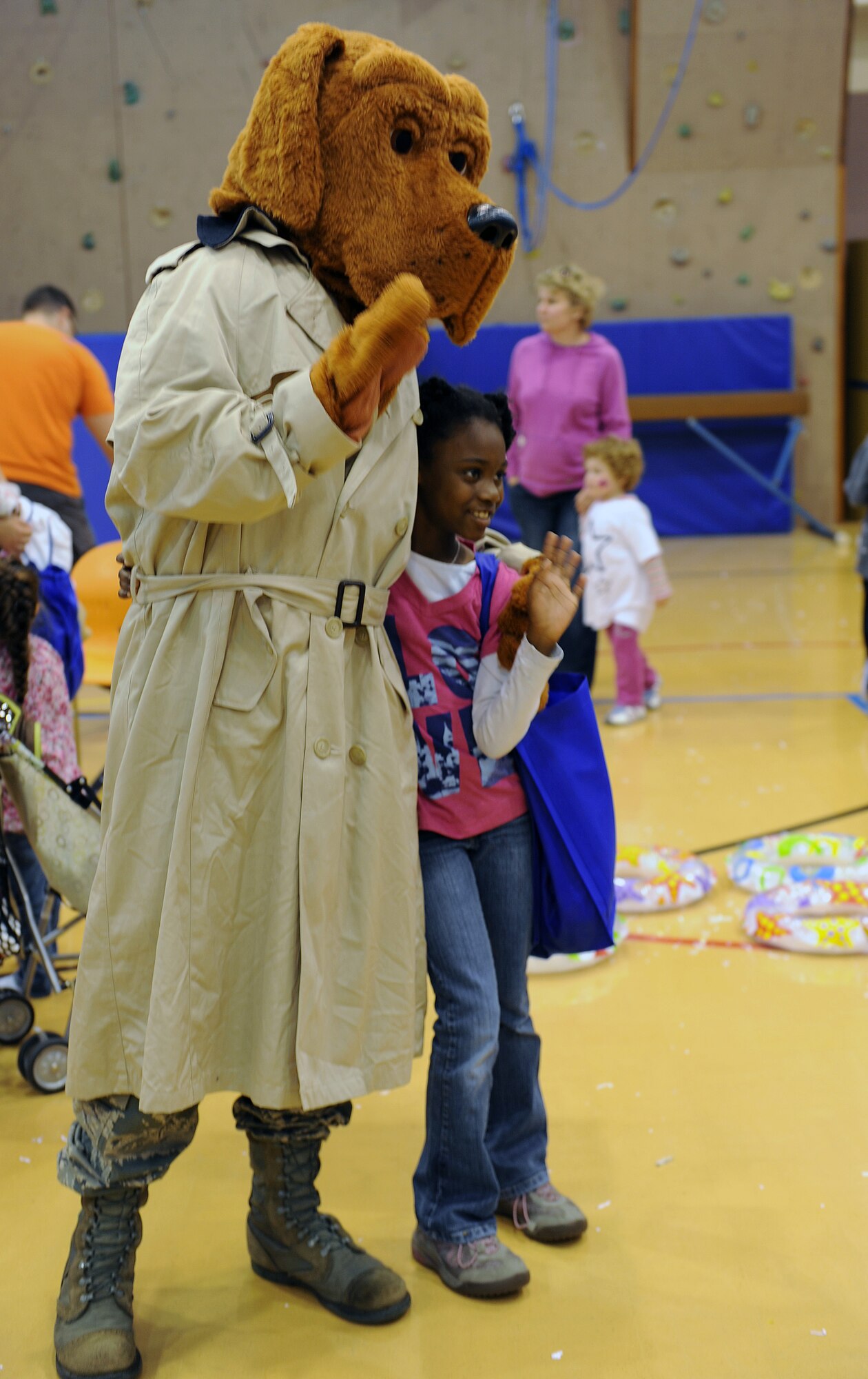 RAF MILDENHALL, England -- A child poses with McGruff the Crime Dog during the Worldwide Day of Play held at the RAF Mildenhall Youth Center Sept. 22, 2012. More than 900 people attended the Worldwide Day of Play which featured games, bouncy castles, Pets as Therapy dogs, go-karts and more. (U.S. Air Force photo/Tech. Sgt. Stacia Zachary)