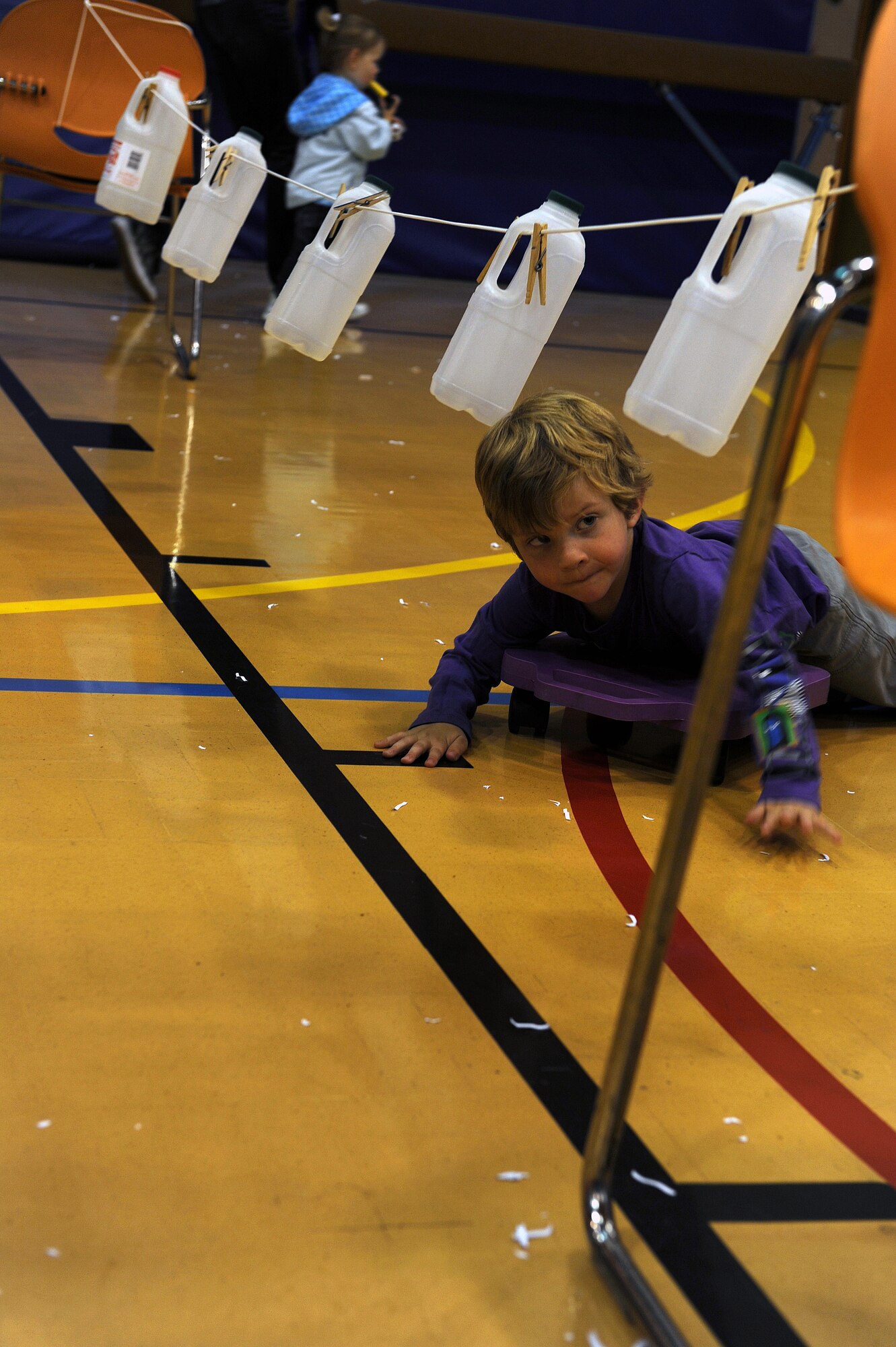 RAF MILDENHALL, England -- Michael Davis lays on a scooter while navigating through an obstacle course during the Worldwide Day of Play held at the RAF Mildenhall Youth Center Sept. 22, 2012. More than 900 people attended the Worldwide Day of Play which featured games, bouncy castles, Pets as Therapy dogs, go-karts and more. (U.S. Air Force photo/Tech. Sgt. Stacia Zachary)