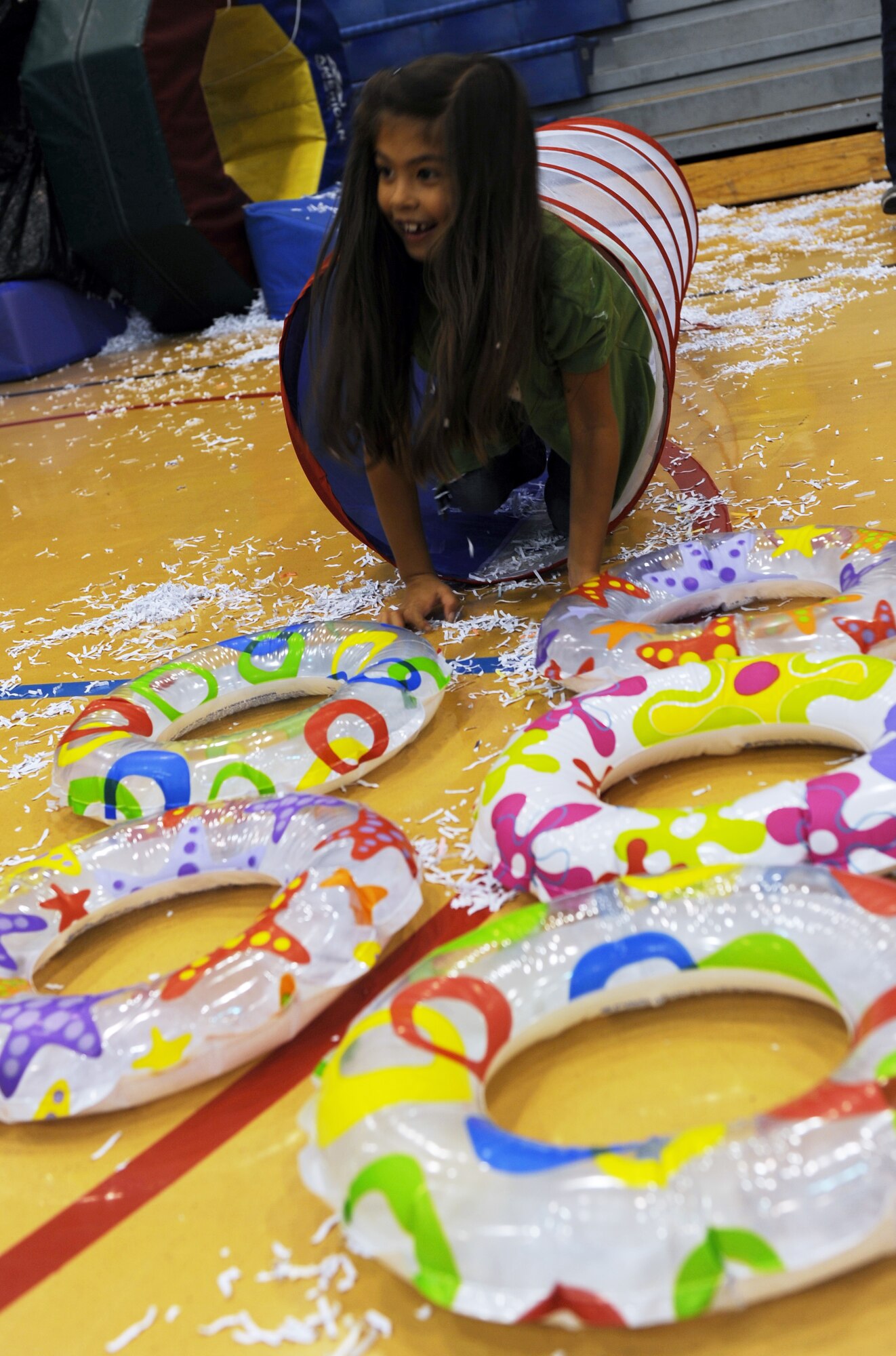 RAF MILDENHALL, England -- Edrine Kengne-Tetsing completes a portion of the shredded paper obstacle course at the RAF Mildenhall Youth Center during the Worldwide Day of Play Sept. 22, 2012. More than 900 American and British people attended the Worldwide Day of Play which featured games, bouncy castles, Pets as Therapy dogs, go-karts and more. (U.S. Air Force photo/Tech. Sgt. Stacia Zachary)