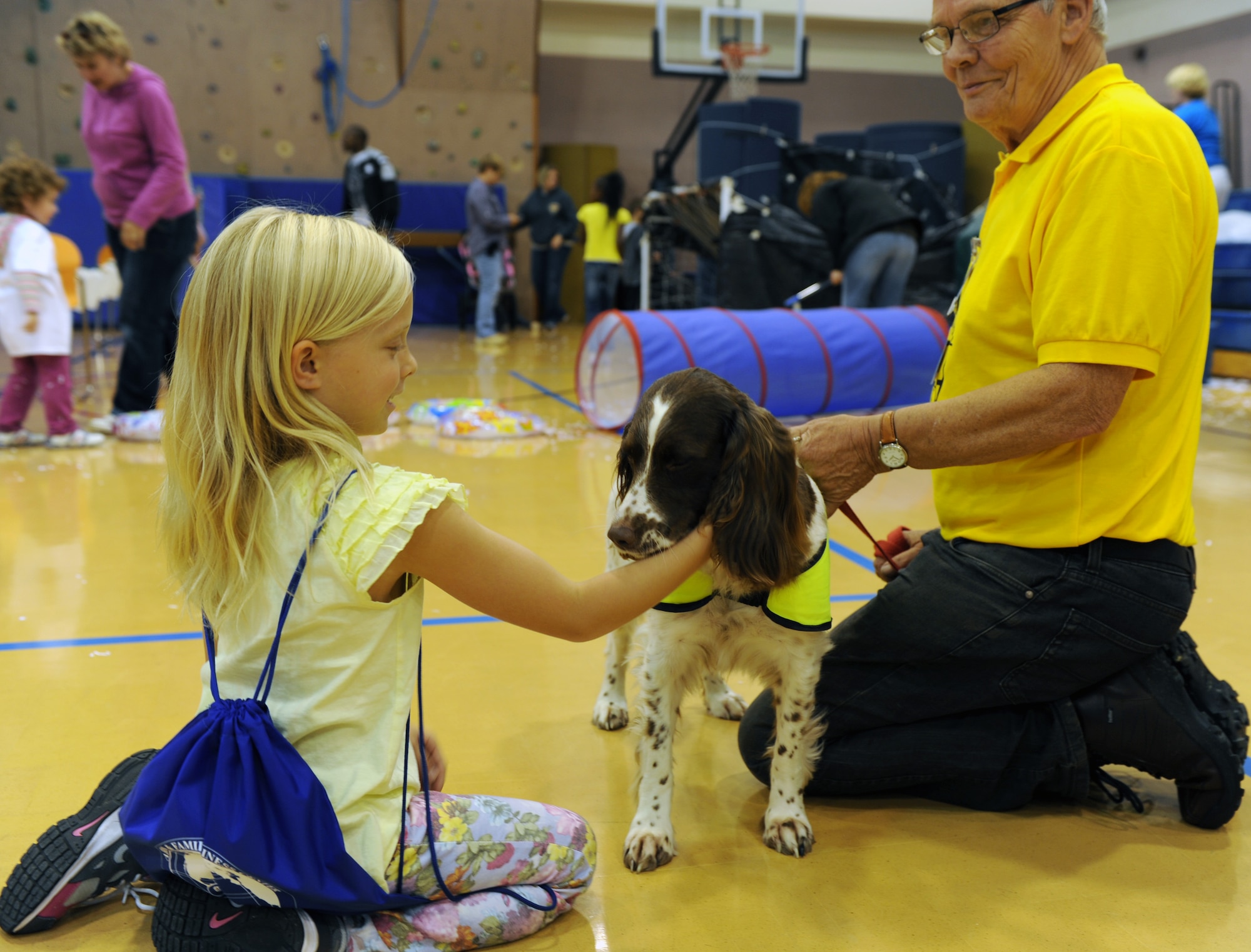 RAF MILDENHALL, England -- Payton Gifford pets a Pets as Therapy dog during the Worldwide Day held at the RAF Mildenhall Youth Center of Play Sept. 22, 2012. More than 900 people attended the Worldwide Day of Play which featured games, bouncy castles, Pets as Therapy dogs, go-karts and more. (U.S. Air Force photo/Tech. Sgt. Stacia Zachary)