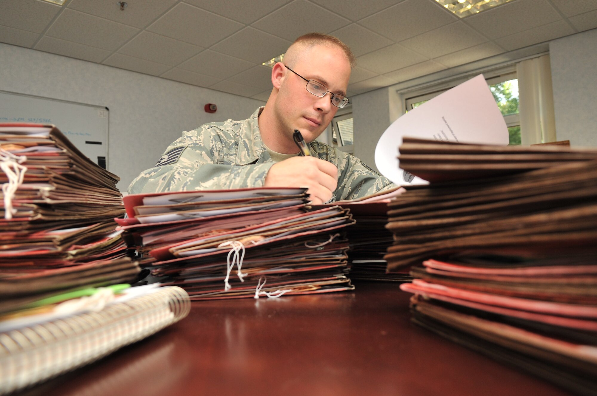 RAF MILDENHALL, England - Tech. Sgt. Bruce T. Nicaise, 100th Force Support Squadron, sorts through mobility folders on Aug.31, 2012 at bldg. 460. (U.S. Air Force photo/Senior Airman Jerilyn Quintanilla)