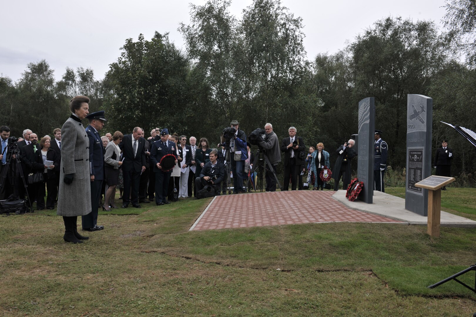 GREENHAM COMMON, United Kingdom – Her Royal Highness, Princess Anne, The Princess Royal and Col. Brian Kelly, 501st Combat Support Wing commander, pause for a moment of silence to honor the American servicemen who were based locally and lost their lives during World War II. Her Royal Highness dedicated three memorial stones for U.S. Visiting Forces at the Greenham Business Park in Greenham Common, United Kingdom, Sept. 21. The three-part memorial is in remembrance of 16 service members killed when two B-17 Flying Fortresses collided above Greenham Common Dec. 15, 1944; 33 Airmen who died just three days earlier when their Horsa Glider crashed on takeoff at the base; and American servicemen who were based locally and lost their lives during World War II. (U.S. Air Force photo by Master Sgt. John Barton)
