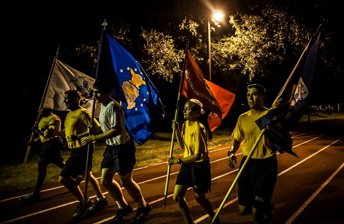 Airmen and Sailors from Joint Base Charleston carry the nation’s armed forces service flags alongside the Prisoner of War/Missing in Action flag during the POW/MIA Run Sept. 20, 2012, at Joint Base Charleston – Air Base, S.C. Different units from the joint base carried the flag for 30 minutes each from 3:30 p.m. Sept. 20 to 3:30 p.m. Sept. 21 in honor of all POWs and MIAs. (U.S. Air Force photo/Senior Airman Dennis Sloan)