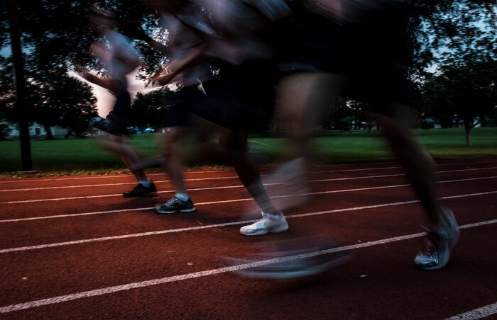 Airmen from the 628th Security Forces Squadron race down the track carrying the Prisoner of War/Missing in Action flag during the POW/MIA Run Sept. 20, 2012, at Joint Base Charleston – Air Base, S.C. Different units from the joint base carried the flag for 30 minutes each from 3:30 p.m. Sept. 20 to 3:30 p.m. Sept. 21 in honor of all POWs and MIAs. (U.S. Air Force photo/Senior Airman Dennis Sloan)