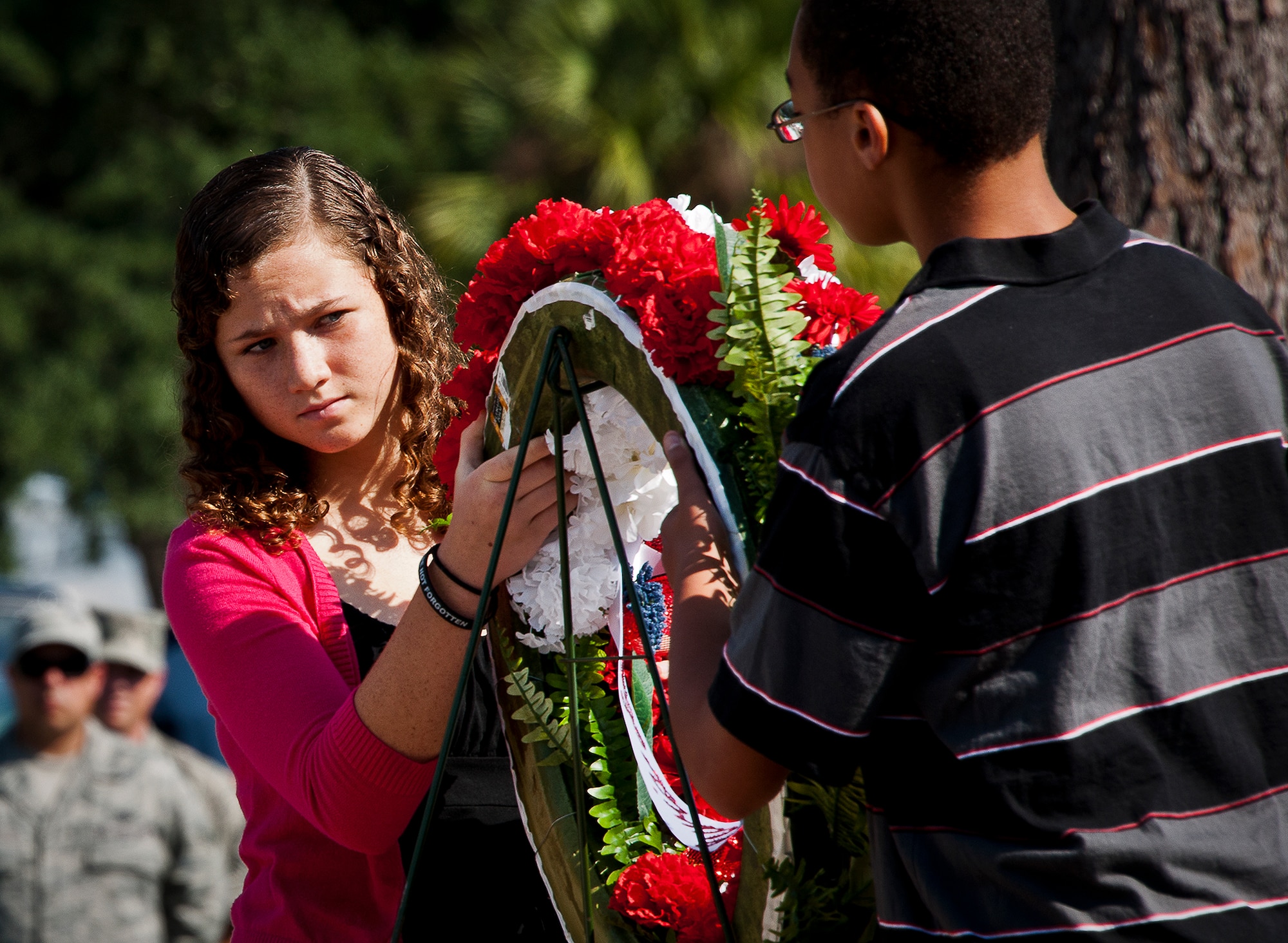 Grace Ratley and Xavier Adams-Stewart, from Addie R. Lewis Middle School, present a wreath during the 2012 Prisoner-of-War, Missing-in-Action ceremony Sept 21 at the Air Force Armament Museum.  The ceremony paid tribute to those military members who have yet to return home from defending America. The event was hosted by the 53rd Wing and featured guest speakers, honor guard procedures and a flyover by the 85th Test and Evaluation Squadron.  (U.S. Air Force photo/Samuel King Jr.)