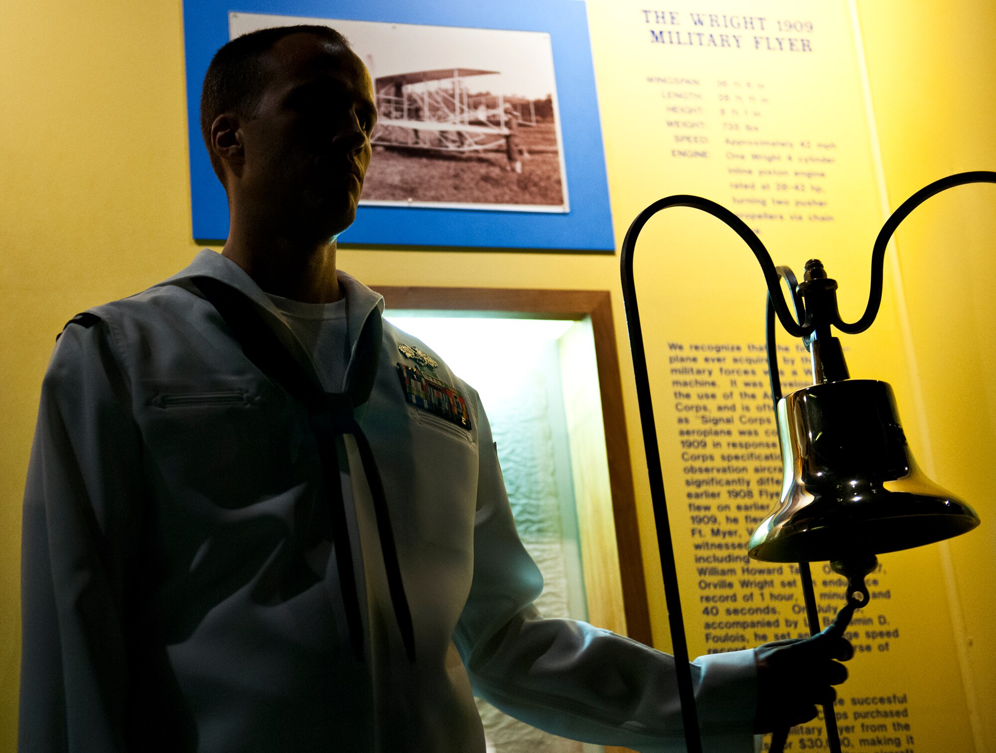 Petty Officer 1st Class Donald Wintersteen rings the bell each time a chorus of voices sounds “We remember” during the Prisoner-of-War, Missing-in-Action table setting ceremony during the POW/MIA event Sept 21 at the Air Force Armament Museum.  The ceremony paid tribute to those military members who have yet to return home from defending America. The event was hosted by the 53rd Wing and featured guest speakers, honor guard procedures and a flyover by the 85th Test and Evaluation Squadron.  (U.S. Air Force photo/Samuel King Jr.)