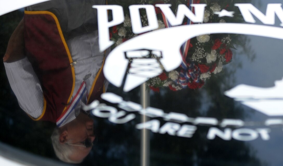 Retired U.S. Navy Commander George Coker, former North Vietnam prisoner of war, recalls his experiences during the POW-MIA ceremony at Langley Air Force Base, Va., Sept. 21, 2012. Coker escaped from his prison in Hanoi in October 1967, but was recaptured after traveling approximately 15 miles. After his release from captivity, he received the Navy Cross, the Legion of Merit, the Silver Star and the POW medal. (U.S. Air Force photo by Senior Airman Racheal Watson/Released)
