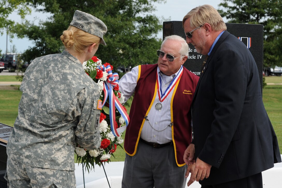 From left, U.S. Army Col. Jayne Jansen, 633rd Air Base Wing vice commander, retired U.S. Navy Commander George Coker, former North Vietnam prisoner of war, and Matthew Hartman, 358 Air Force Sergeant Association chapter president, place a wreath on the POW-MIA memorial at Langley Air Force Base, Va., Sept. 21, 2012. People across the United States pause to remember the sacrifices and service of those who were imprisoned, and are missing in action, in addition to their families. (U.S. Air Force photo by Senior Airman Racheal Watson/Released)