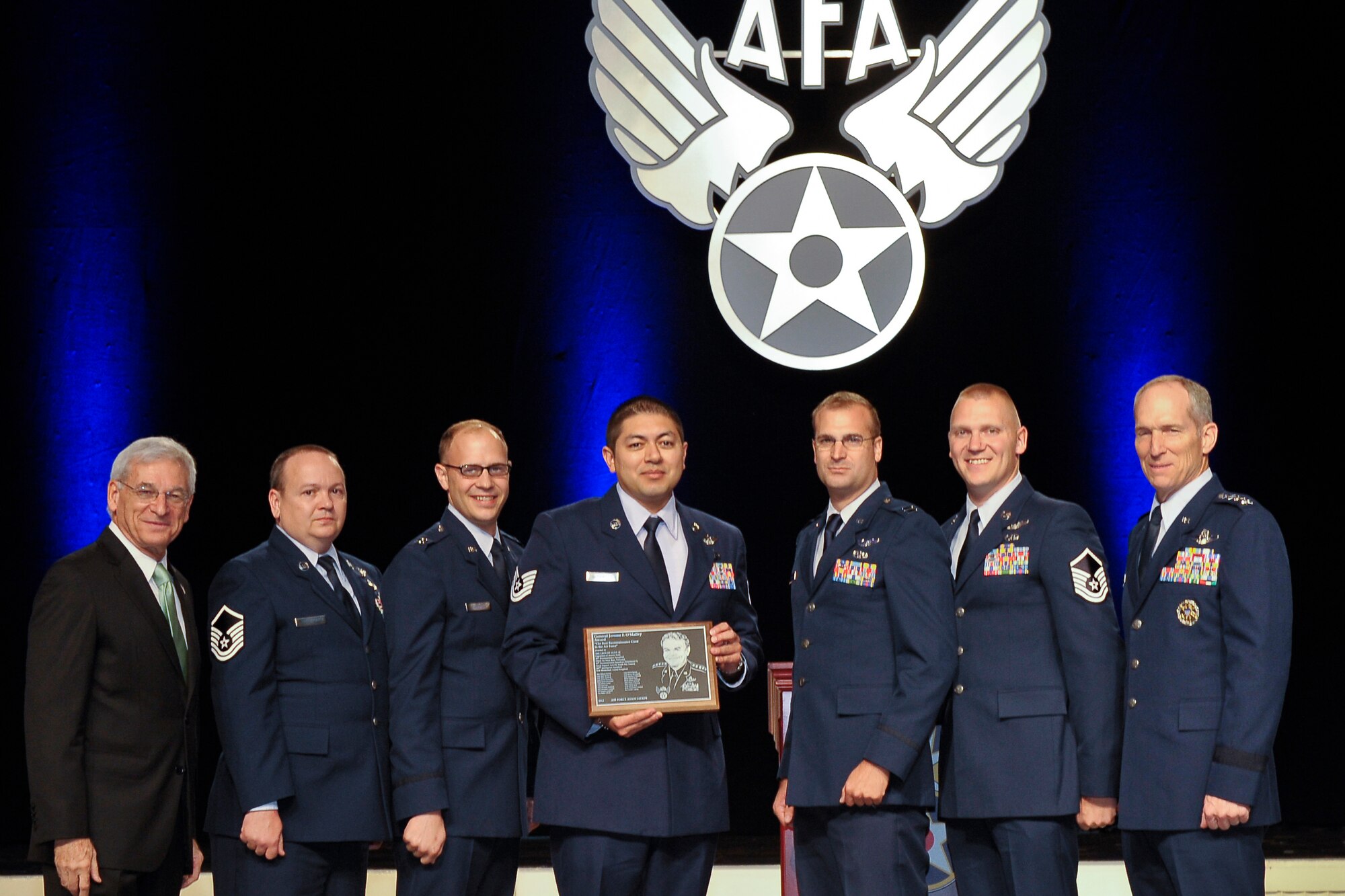 WASHINGTON D.C. -- Representatives of the crew of Olive 22 receive the 2012 Jerome F. O' Malley Award at the Air Force Association Symposium, Washington, D.C., Sept. 17, 2012, naming them the best reconnaissance crew in the U.S. Air Force for 2012. The crew receiving the award were, second from left, Master Sgt. David Honsinger, 488th Intelligence Squadron, RAF Mildenhall, England; Capt. Tyler Sandberg, 173rd Air Refueling Squadron, Nebraska Air National Guard, Lincoln, Neb.; Tech. Sgt. Carlos Gutierrez, 390th Intelligence Squadron, Kadena Air Base, Japan; Capt David Buxton, 338th Combat Training Squadron, Offutt Air Force Base, Neb. and Master Sgt. David Johnston, 38th Reconnaissance Squadron, Offutt AFB. The award was presented by, left, S. Sanford Schlitt AFA Chairman of the Board and, right, Gen. Mike G. Hostage III Commander, Air Combat Command. Additional recipients of the award (not shown) are Maj. Clifford Morgan, Tech. Sgt. Michelle Martinez, Tech. Sgt. Joshua Mort, Staff Sgt. Benjamin Garmier, Staff Sgt. Christopher Whalen, Senior Airman Angela Gayheart, Senior Airman Joseph Lagang, Master Sgt. Robert Baird, Master Sgt. Jeffrey LeMaster, Tech. Sgt. Alfred Denny, and Tech. Sgt. Jacob Fox all of the  488th IS. (U.S. Air Force photo /Michael J. Pausic)