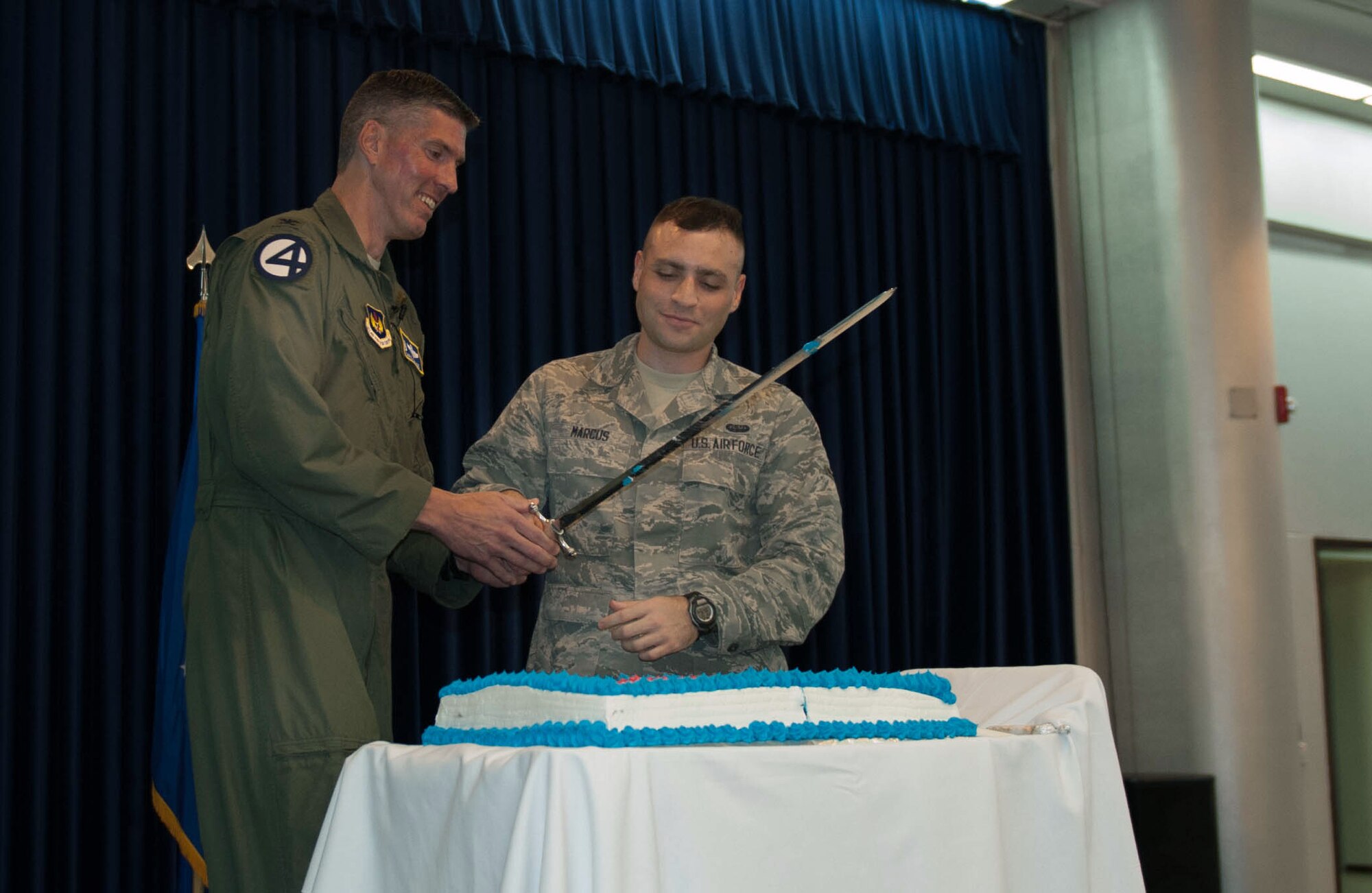 Col. Chris Craige, 39th Air Base Wing commander, left, and Airman Cody Marcus, 39th Communications Squadron, cut a cake as part of the celebration for the Air Force's 65th birthday Sept. 21, 2012, at Incirlik Air Base, Turkey. It is tradition that the highest and the lowest ranking members on base cut the cake during Air Force birthday celebrations. (U.S. Air Force photo by Senior Airman Anthony Sanchelli/Released)
