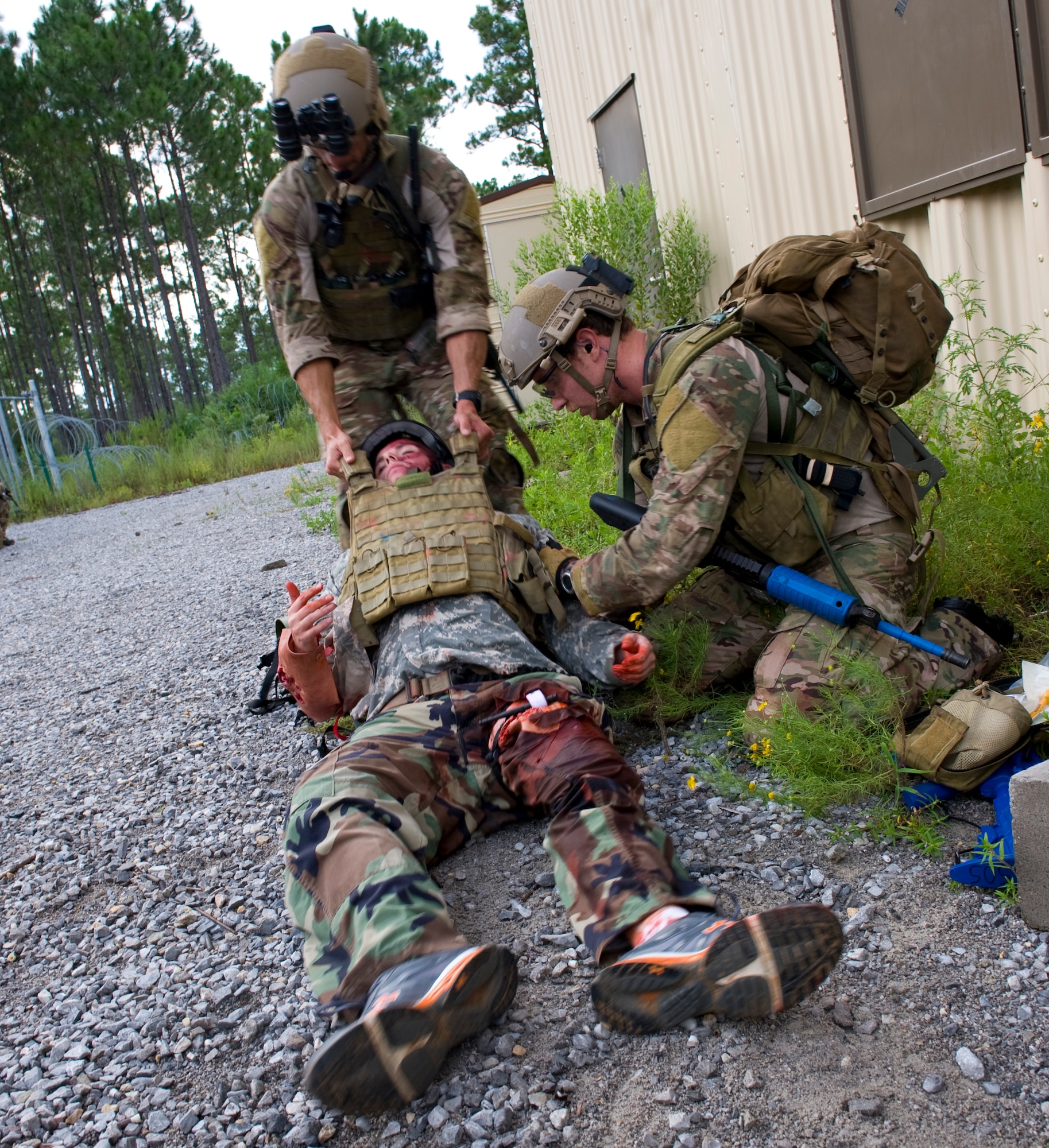 U.S. Air Force pararescuemen with 23rd Special Tactics Squadron administer Self Aid Buddy Care to a patient injured in a simulated improvised explosive device explosion on Eglin Range, Fla., Aug. 21, 2012. The pararescuemen were removing casualties from a building where a simulated improvised explosive device went off as during training exercise. (U.S. Air Force Photo/ Staff Sgt. John Bainter)
