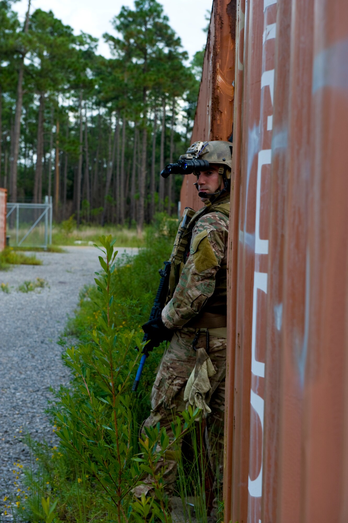 A U.S. Air Force pararescueman with 23rd Special Tactics Squadron provides cover from between two rail cars during a simulated improvised explosive device training exercise on Eglin Range, Fla., Aug. 21, 2012.  He provided cover for an evacuation team transporting a simulated combat casualty. (U.S. Air Force Photo/Staff Sgt. John Bainter)
