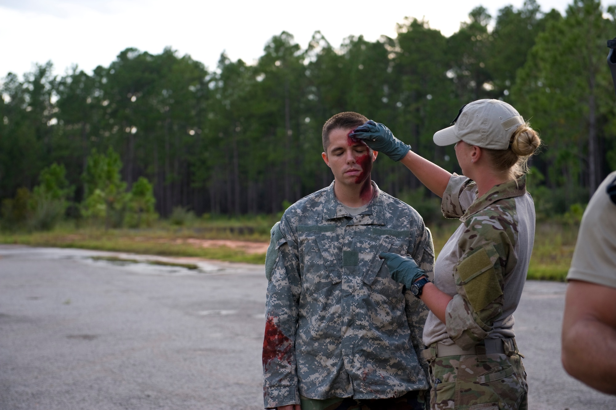 U.S. Air Force Staff Sgt. William Collier, an aerial gunner with 4th Special Operations Squadron, gets moulage applied to his face on Eglin Range, Fla., Aug. 21, 2012. Collier was a simulated casualty as part of a tactical readiness specialist training exercise.  (U.S. Air Force Photo/Staff Sgt. John Bainter)
