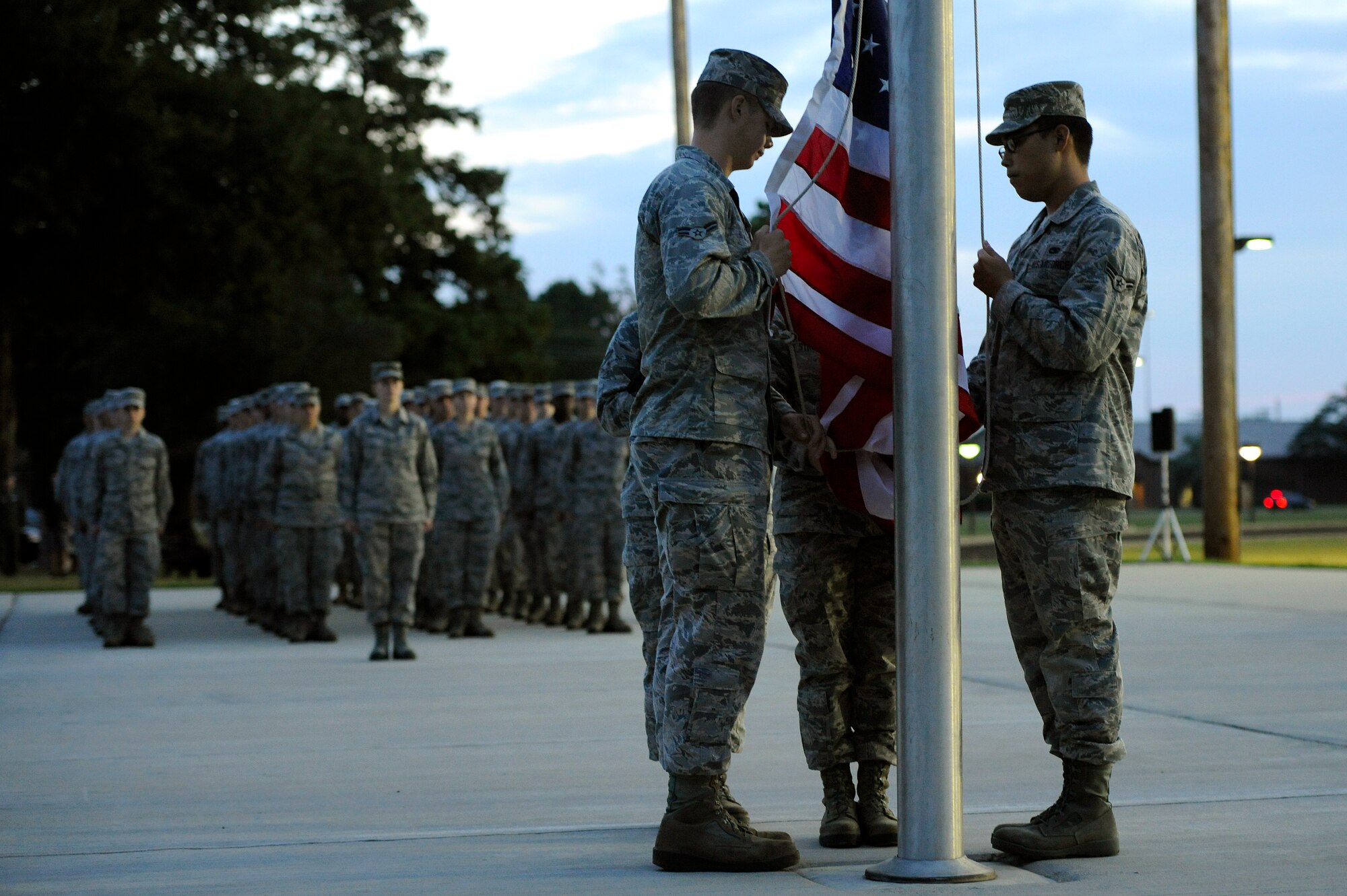 U.S. Air Force Airmen assigned to the 20th Aircraft Maintenance Squadron raise the American and Prisoner of War/Missing in Action flags during a POW/MIA flag raising ceremony, Sept. 20, 2012, Shaw Air Force Base, S.C. After the ceremony, Airmen began a 24-hour POW/MIA remembrance run. (U.S. Air Force photo by Senior Airman Kenny Holston/Released)