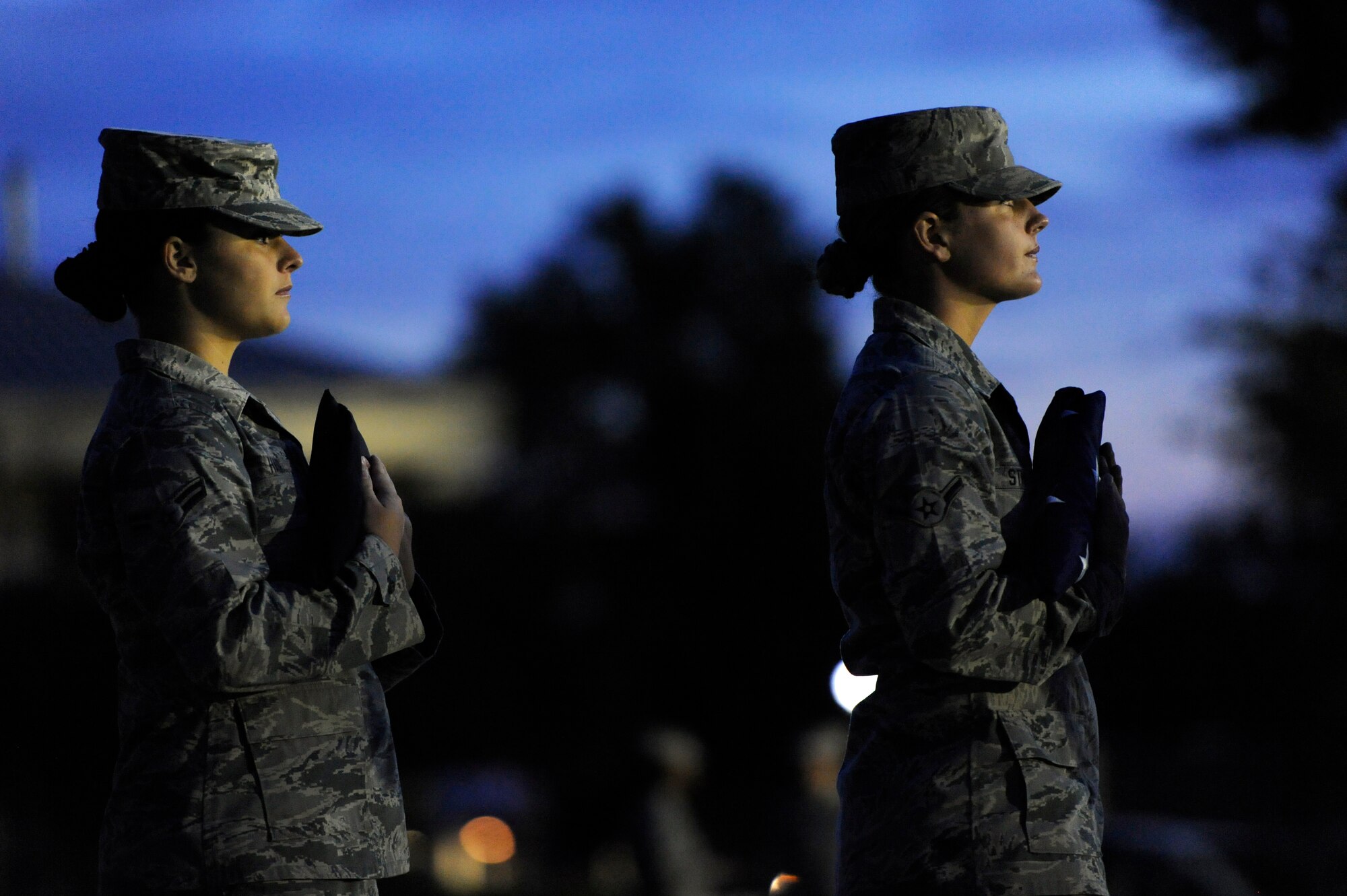 U.S. Air Force Airman 1st Class Caitlin Hair, 20th Aircraft Maintenance Squadron, (left), and Airman Randi Stroup, 20th Aircraft Maintenance Squadron, hold the American and Prisoner of War/Missing in Action flags while in formation at the start of a POW/MIA flag raising ceremony, Sept. 20, 2012, Shaw Air Force Base, S.C. After the ceremony, Airmen began a 24-hour POW/MIA remembrance run. (U.S. Air Force photo by Senior Airman Kenny Holston/Released)