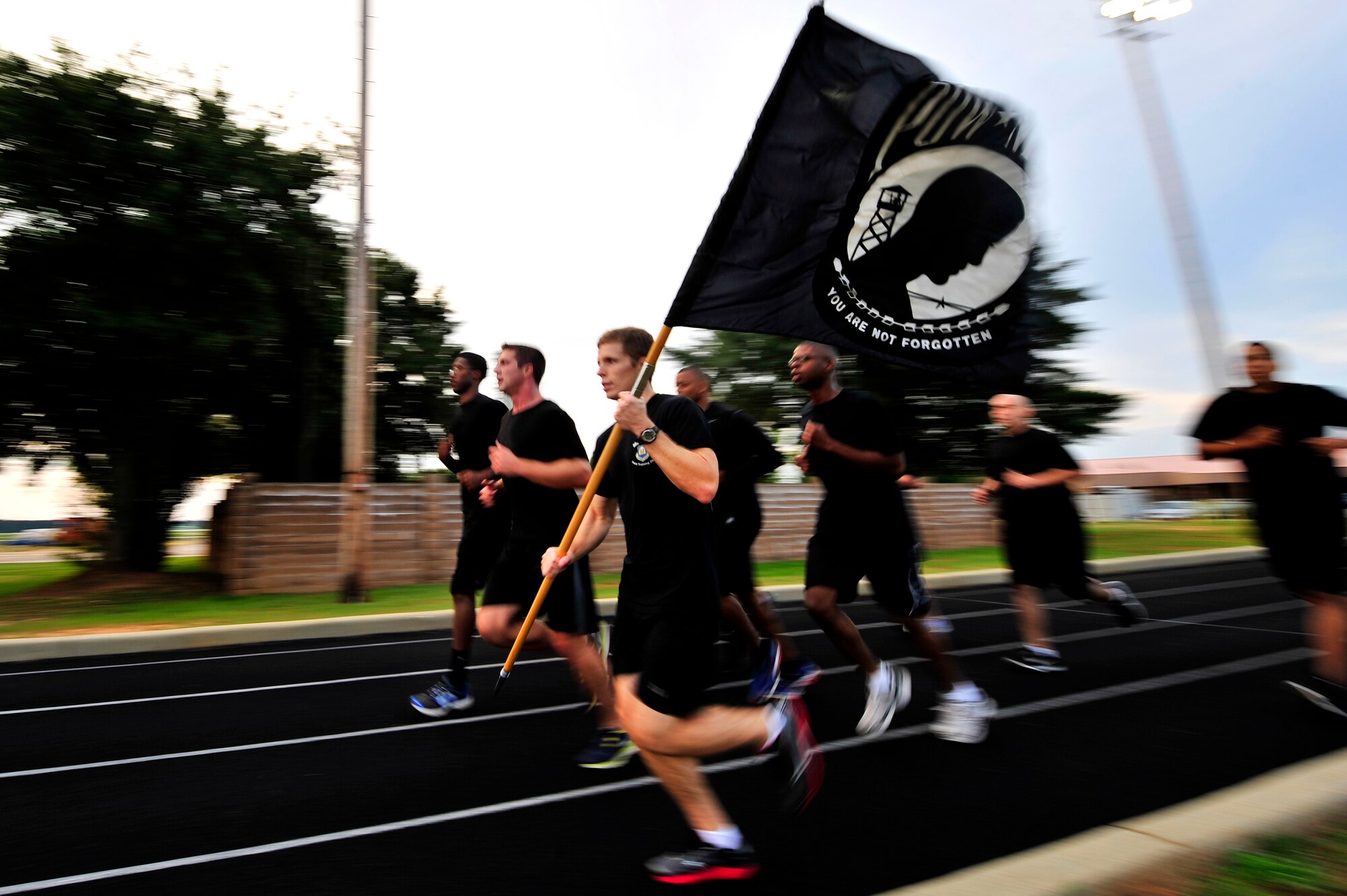U.S. Air Force Airmen assigned to the 20th Comptrollers Squadron pick up their pace as they participate in a 24-hour Prisoner of War/Missing in Action remembrance run, Sept. 20, 2012, Shaw Air Force Base, S.C. Team Shaw Airmen from several different units participated in the 24-hour run in honor of those service men and women who are and where POW /MIA. (U.S. Air Force photo by Senior Airman Kenny Holston/Released)