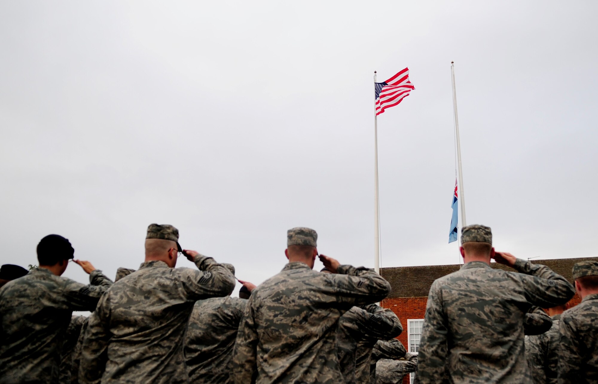 RAF MILDENHALL, England – Team Mildenhall Airmen salute the American and Royal Air Force Ensign during a special retreat ceremony in honor of Prisoner of War/Missing in Action Remembrance week Sept. 21, 2012, at RAF Mildenhall. POW/MIA week is a time for the nation to pay respect to the men and women of America who sacrificed in the defense of their country. (U.S. Air Force photo/Senior Airman Ethan Morgan)