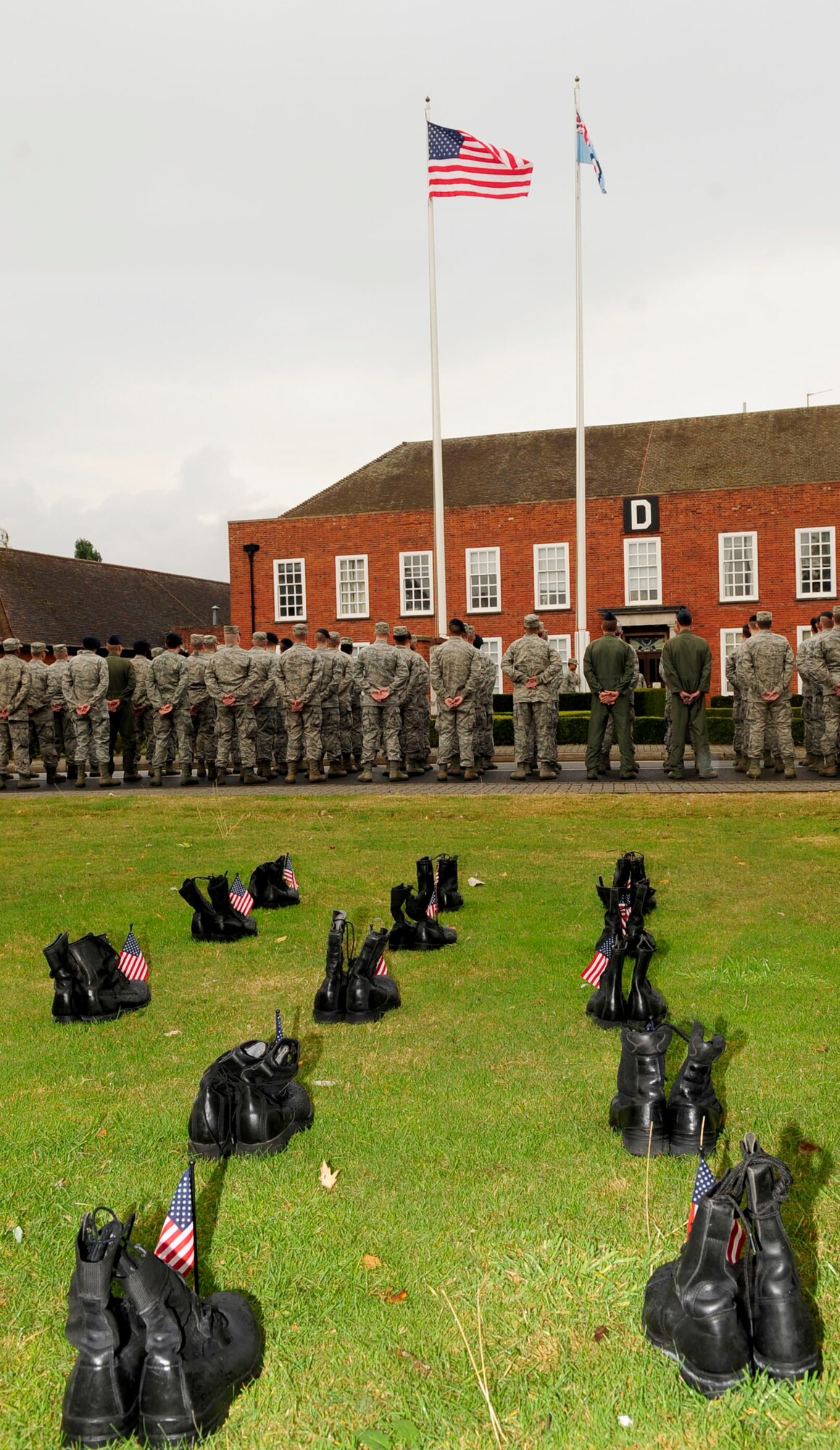 RAF MILDENHALL, England – Team Mildenhall Airmen stand at parade rest while waiting for retreat to sound during a retreat ceremony for Prisoner of War/Missing in Action Remembrance week, Sept. 21, 2012, at RAF Mildenhall. POW/MIA week is a time for the nation to pay respect to the men and women of America who sacrificed in the defense of their country. (U.S. Air Force photo/Senior Airman Ethan Morgan) 