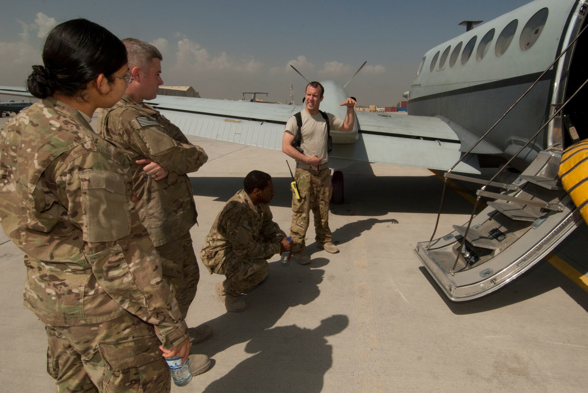 Airmen assigned to the 455th Air Expeditionary Wing listen as SSgt Jeffrey Blount, 4th Expeditionary Reconnaissance Squadron MC-12 Liberty sensor operator, talks about his duties during the AF Enlisted Career Field Expo at Bagram Airfield, Afghanistan, Sept. 23, 2012. About a dozen booths were set up in the Combat Orientation tent at Camp Cunningham where Airmen could learn about cross-training into various chronically-critical and special duty assignments. Various airframes were also made available for Airmen to view while learning about several career fields with a flying role. (U.S. Air Force photo/SSgt Jeff Nevison)