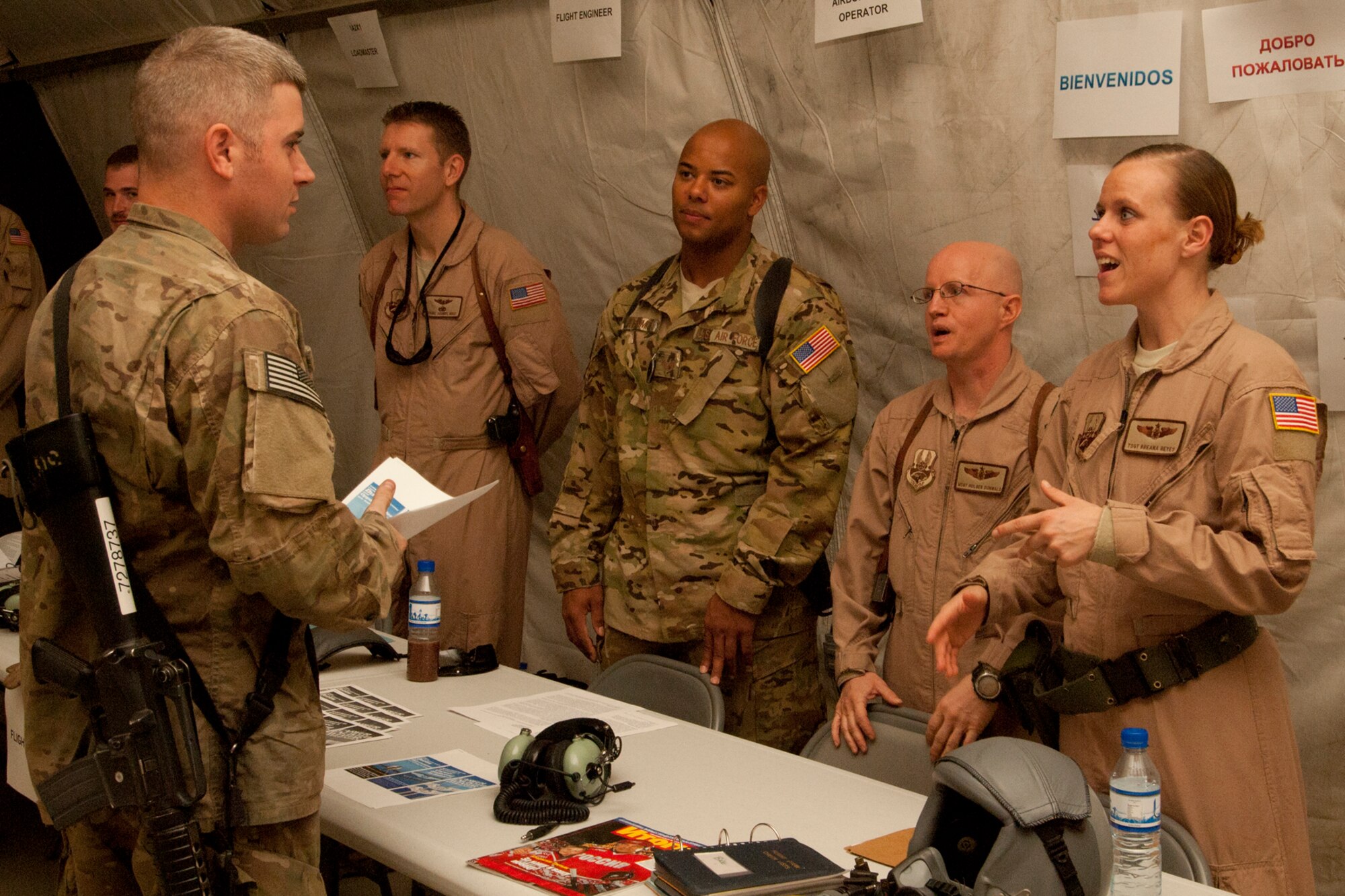 SrA Jacob Atkinson (left), 455th Expeditionary Logistics Readiness Squadron Travel Movement Office discusses career cross-training possibilities with TSgt Breana Reyes 41st Expeditionary Electronic Combat Squadron operations during the AF Enlisted Career Field Expo at Bagram Airfield, Afghanistan, Sept. 23, 2012. About a dozen booths were set up in the Combat Orientation tent at Camp Cunningham where Airmen could learn about cross-training into various chronically-critical and special duty assignments. (U.S. Air Force photo/SSgt Jeff Nevison)