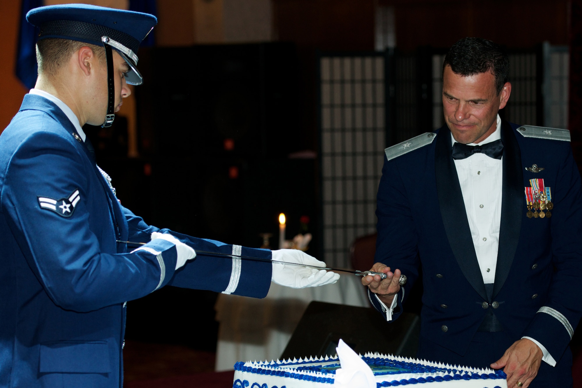 U.S Air Force Brig. Gen. Matt Molloy, 18th Wing commander, accepts a sabre to cut the cake at the Air Force Ball on Kadena Air Base, Japan, Sept. 22, 2012.  More than 1,000 service members and their spouses attended the ball, which is an annual Air Force-wide tradition to celebrate the heritage and history of the Air Force. (Courtesy photo)