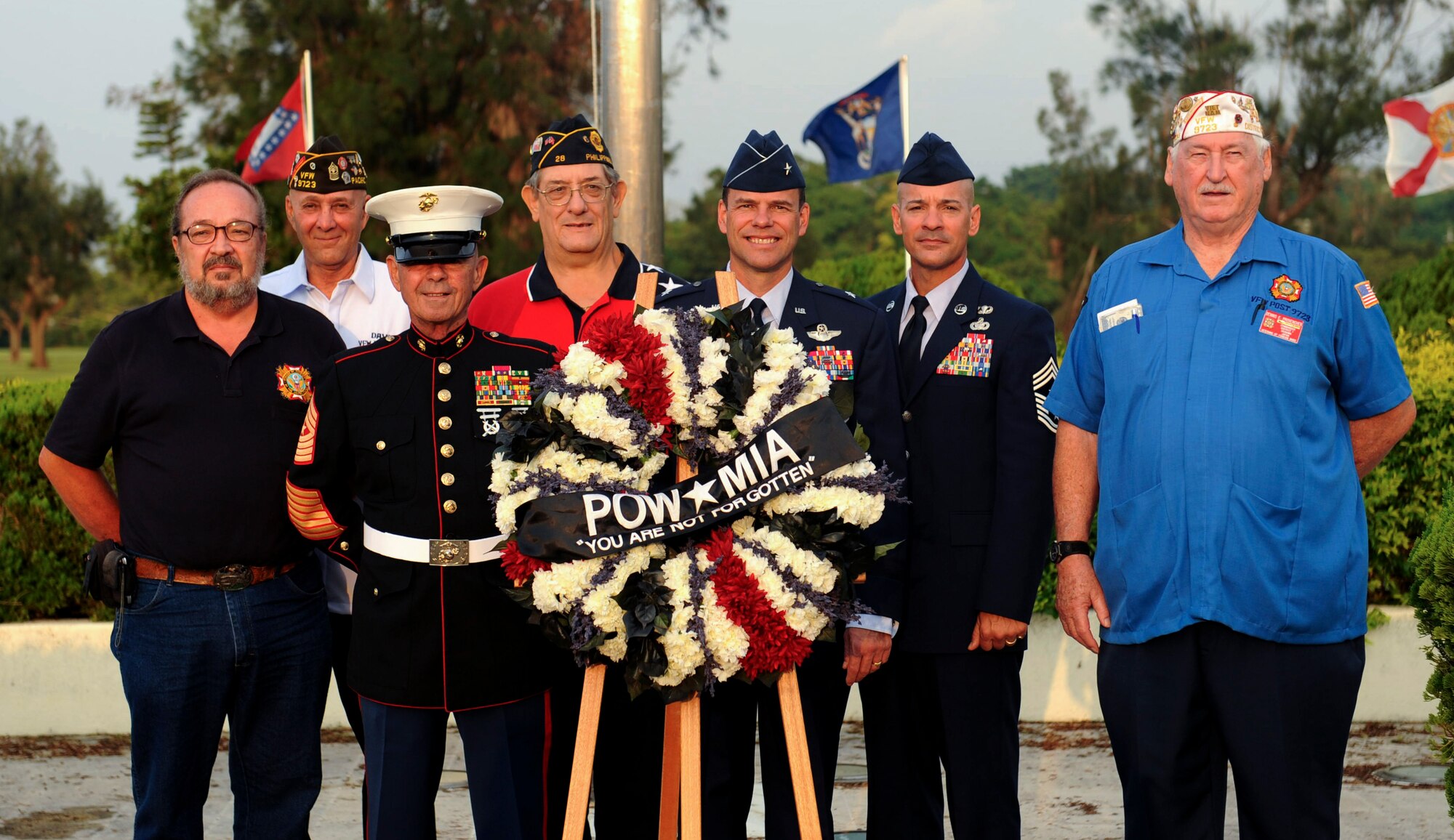 Retired U.S. Marine Corps Sgt. Maj. Peter M. Gorczewski, U.S. Air Force Brig. Gen. Molloy, 18th Wing commander, and Chief Master Sgt. Mark Marson, 18th Wing command chief, stand with veterans during the Prisoners of War/Missing in Action flag ceremony on Kadena Air Base, Japan, Sept. 21, 2012. The National POW/MIA Recognition Day is observed on the third Friday of September every year, but it is important to always remember the sacrifice of prisoners of war and those missing in action. (U.S. Air Force photo/Airman 1st Class Hailey Davis)     