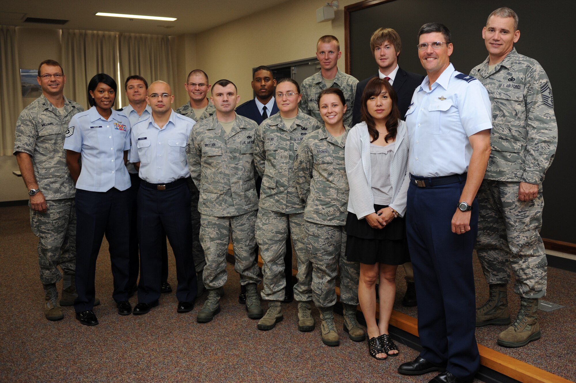 Consolidated Unit Inspection top performers pose for a photograph with wing leadership after being coined by the Pacific Air Forces Inspector General during the CUI out-brief at Misawa Air Base, Japan, Sept. 24, 2012. The 35th Fighter Wing received an overall score of satisfactory for the CUI. (U.S. Air Force photo by Airman 1st Class Kia Atkins)