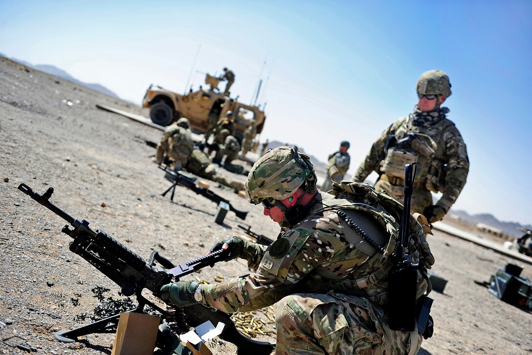 U.S. Navy Chief Petty Officers Eric Greenwald, front, and Joshua Oswald, back, train on an M-240B machine gun on Forward Operating Base Farah in Afghanistan's Farah province, Sept. 22, 2012. Greenwald, an electronics technician, and Oswald are assigned to Provincial Reconstruction Team Farah. 
