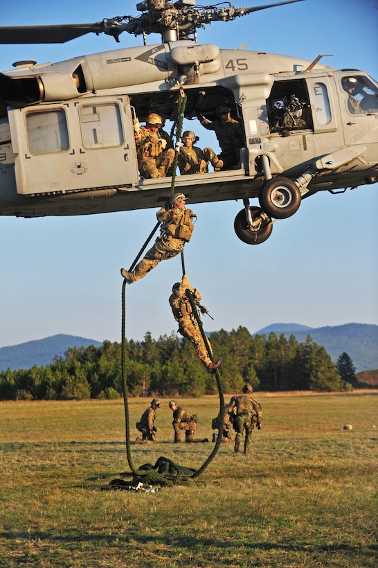 U.S. and Croatian soldiers fast rope from an HH-60H Seahawk helicopter during exercise Jackal Stone 2012 in Udbina, Croatia, Sept. 18, 2012.