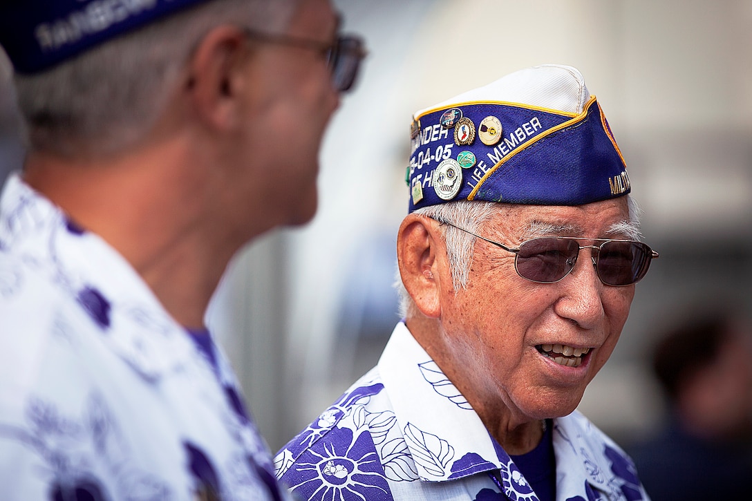 Tommy Tanaka, right, an Army veteran wounded in the Vietnam War, converses with fellow wounded Army veteran Reinaldo Espada before a National Prisoner of War and Missing in Action Recognition Day ceremony at the National Memorial Cemetery of the Pacific in Honolulu, Sept. 21, 2012. Veterans and active duty service members were among the approximately 500 attendees. During the ceremony, retired Army Col. William S. Reeder Jr., spoke about his year spent as a POW in Vietnam after his plane was shot down during combat operations.