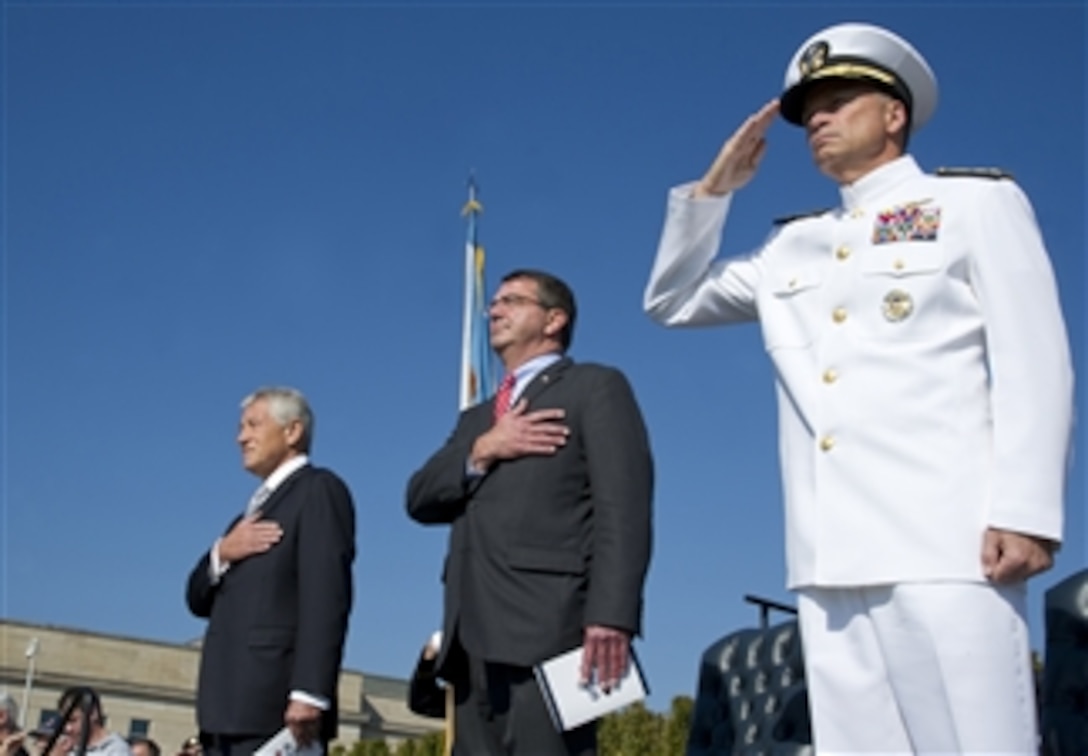 Former Senator Chuck Hagel, left, Deputy Secretary of Defense Ashton B. Carter, center, and Vice Chairman of the Joint Chiefs of Staff Adm. James A. Winnefeld stand for the playing of the National Anthem during National POW/MIA Recognition Day at the Pentagon on Sept. 21, 2012.  The ceremony hosted former prisoners of war, family members, military service members and distinguished guests.  