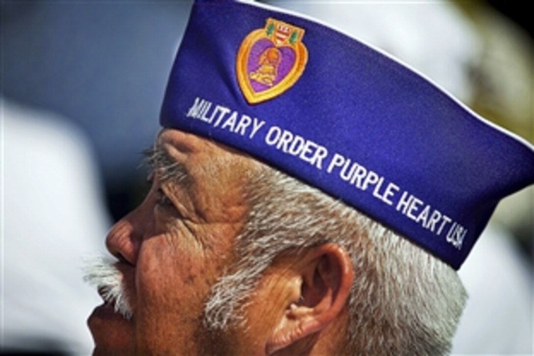 Francisco Mote Sagario, an Army veteran wounded in the Vietnam War, watches a presentation of memorial wreaths during a ceremony to mark National POW/MIA Recognition Day at the National Memorial Cemetery of the Pacific in Honolulu, Sept. 21, 2012.