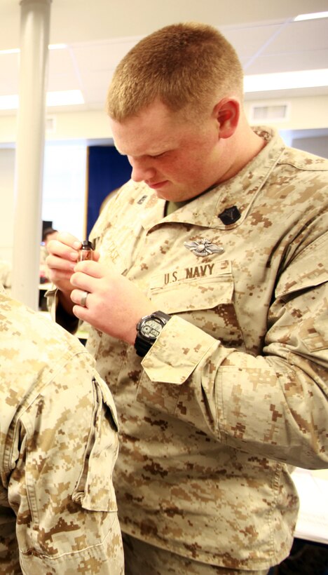 A sailor with 2nd Medical Battalion, 2nd Marine Logistics Group examines a specimen during the Preventive Medicine Petty Officers’ course aboard Camp Lejeune, N.C., Sept. 18, 2012. The duties of a preventive medicine technician include pest management, disease prevention and education, and environmental health, which covers testing the air, water and soil for contaminants. 