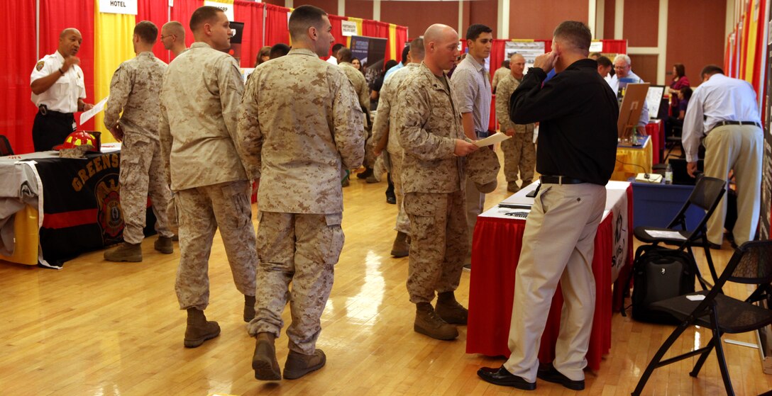 Marines, sailors and dependents look around and talk to different employers while hoping to find a job to interest them during the Job Fair and Career Exposition aboard Marine Corps Base Camp Lejeune Sept. 19. There were approximately 80 employers and 55 schools in attendance to make their pitches to interested patrons.