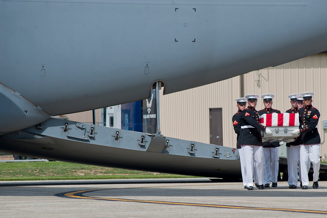 Marines from Marine Barracks Washington carry one of the flag-draped transfer cases of the remains of U.S. Ambassador to Libya, Chris Stevens, and three other Americans that were killed in an attack this week in Benghazi, Libya, during a dignified transfer of remains ceremony at Joint Base Andrews, Md., Sept. 14. Notable attendees to the event were the president of the United States, Barack Obama, U.S. Secretary of State Hillary Clinton, U.S. senator John McCain and Gen. Joseph Dunford, assistant commandant of the Marine Corps.
