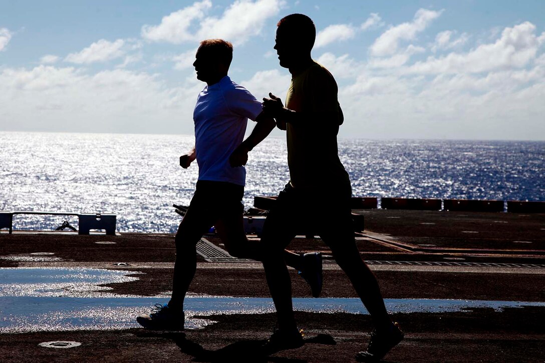 Marines with the 15th Marine Expeditionary Unit run on the flight deck of the USS Peleliu, Sept. 23. The 15th MEU is currently embarked as part of the Peleliu Amphibious Ready Group, while they serve as the nation's rapid-response sea-based Marine Air Ground Task Force for Western Pacific Deployment 12-02.