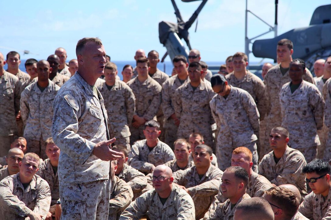 Colonel Scott D. Campbell, commanding officer, 15th Marine Expeditionary Unit, talks to his Marines and sailors during a formation on the flight deck of the USS Peleliu, Sept. 23.  The MEU is currently embarked about the Peleliu Amphibious Ready Group for a Western Pacific deployment.   
