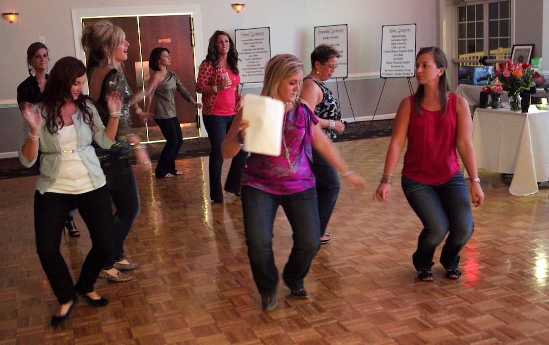 Attendees of the Diamonds and Denim event held at the Jacksonville Country Club Sept. 20 dance to live music provided by local band Notorious Clam Slammers.  