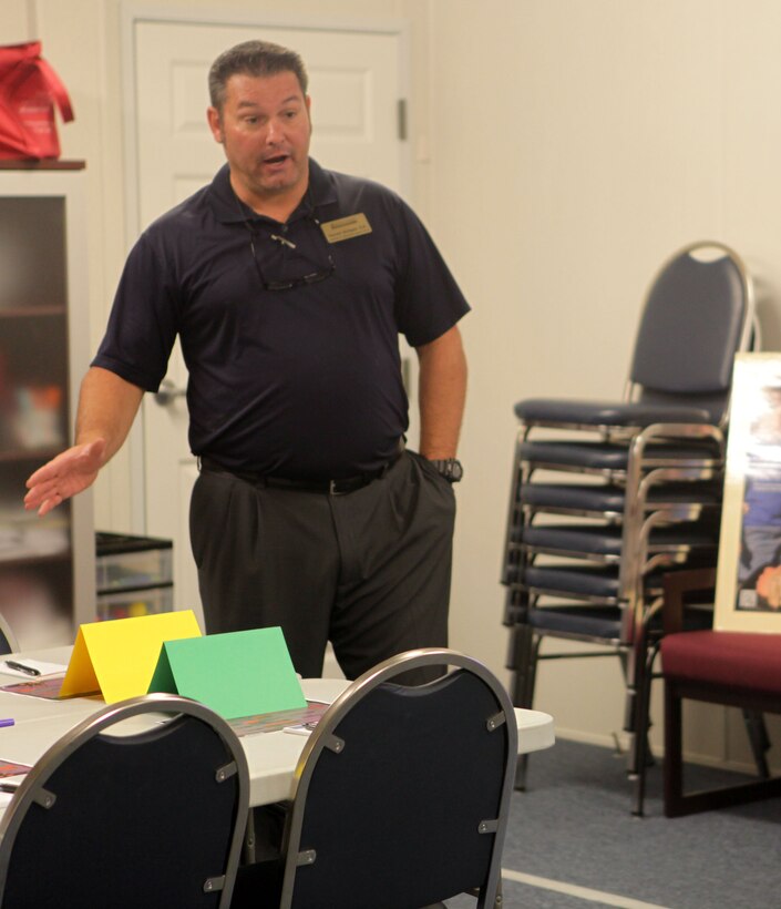 Garrett Bridges, readiness and deployment support trainer, introduces financial specialist Lewis Summerville to teach ‘Beyond the Brief’ class at Midway Park aboard Marine Corps Base Camp Lejeune Sept. 19.  The class is geared towards spouses to give guidance on how to manage money when their wife or husband is deployed.