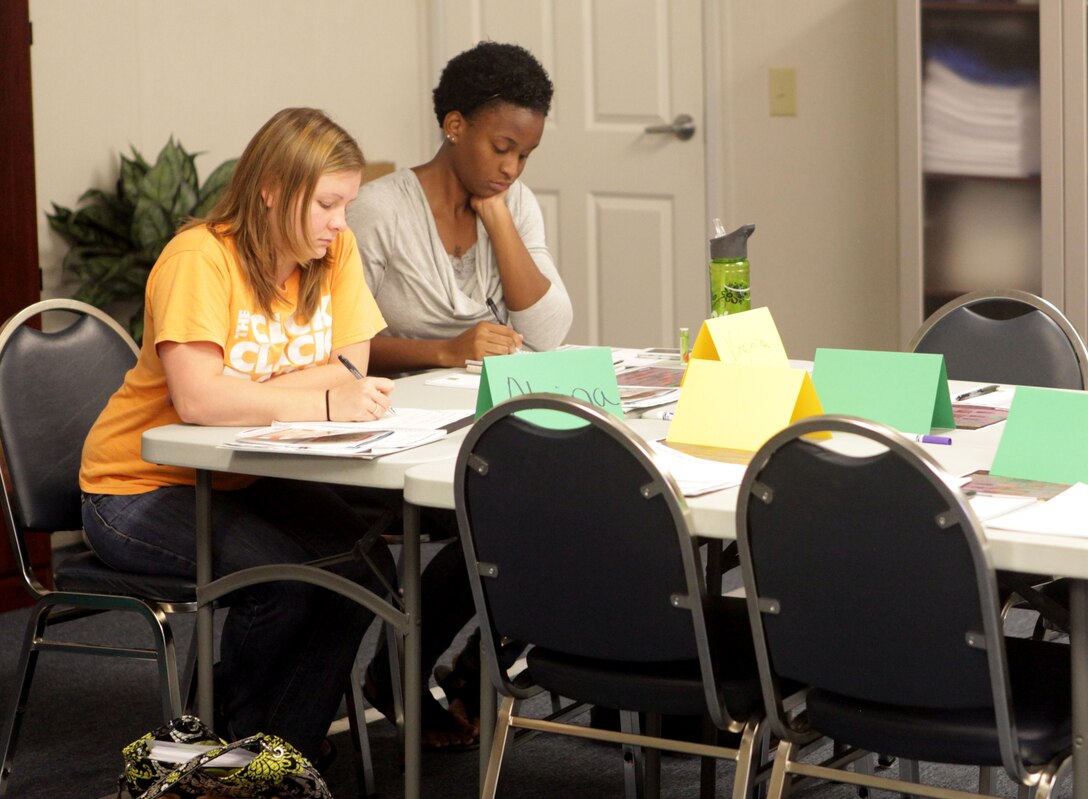 Military spouses, Alaina Hess and Virginia Freeman, take notes on how to manage money  at the ‘Beyond the Brief’ class held at Midway Park aboard Marine Corps Base Camp Lejeune Sept. 19.  Both wives have husbands about to deploy.